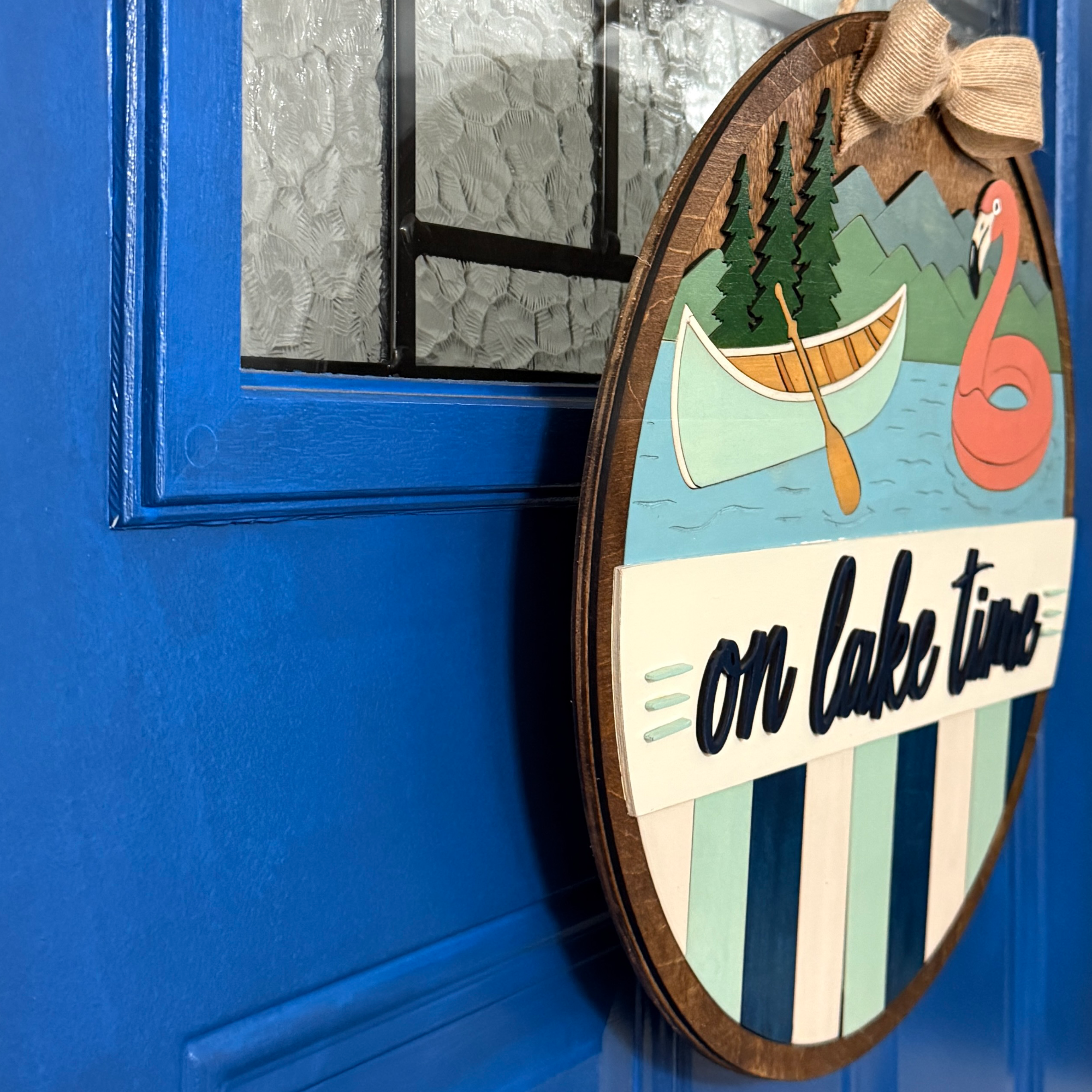 Side angle of layered On Lake Time wood door hanger showing dimensional construction.