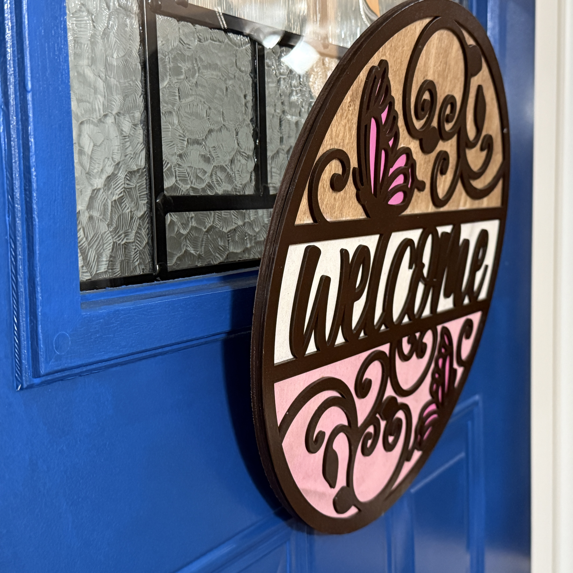 Butterfly Welcome door hanger, side view, showing base thickness and layered wood details