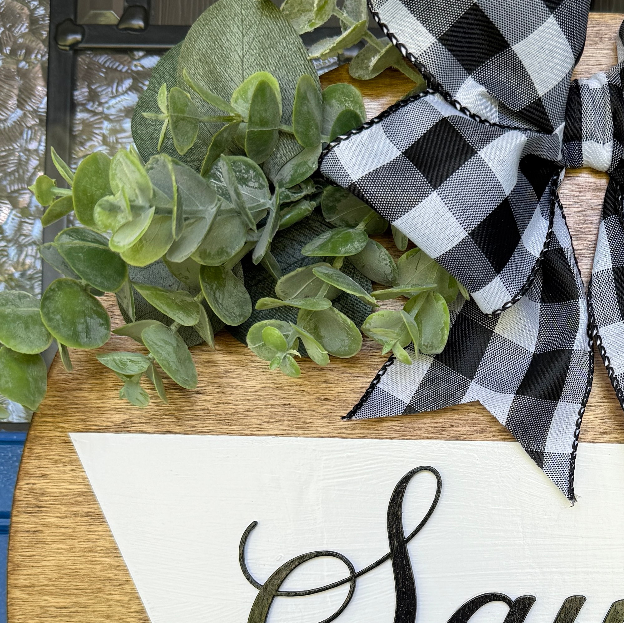 Custom established sign featuring family name and decorative greenery.