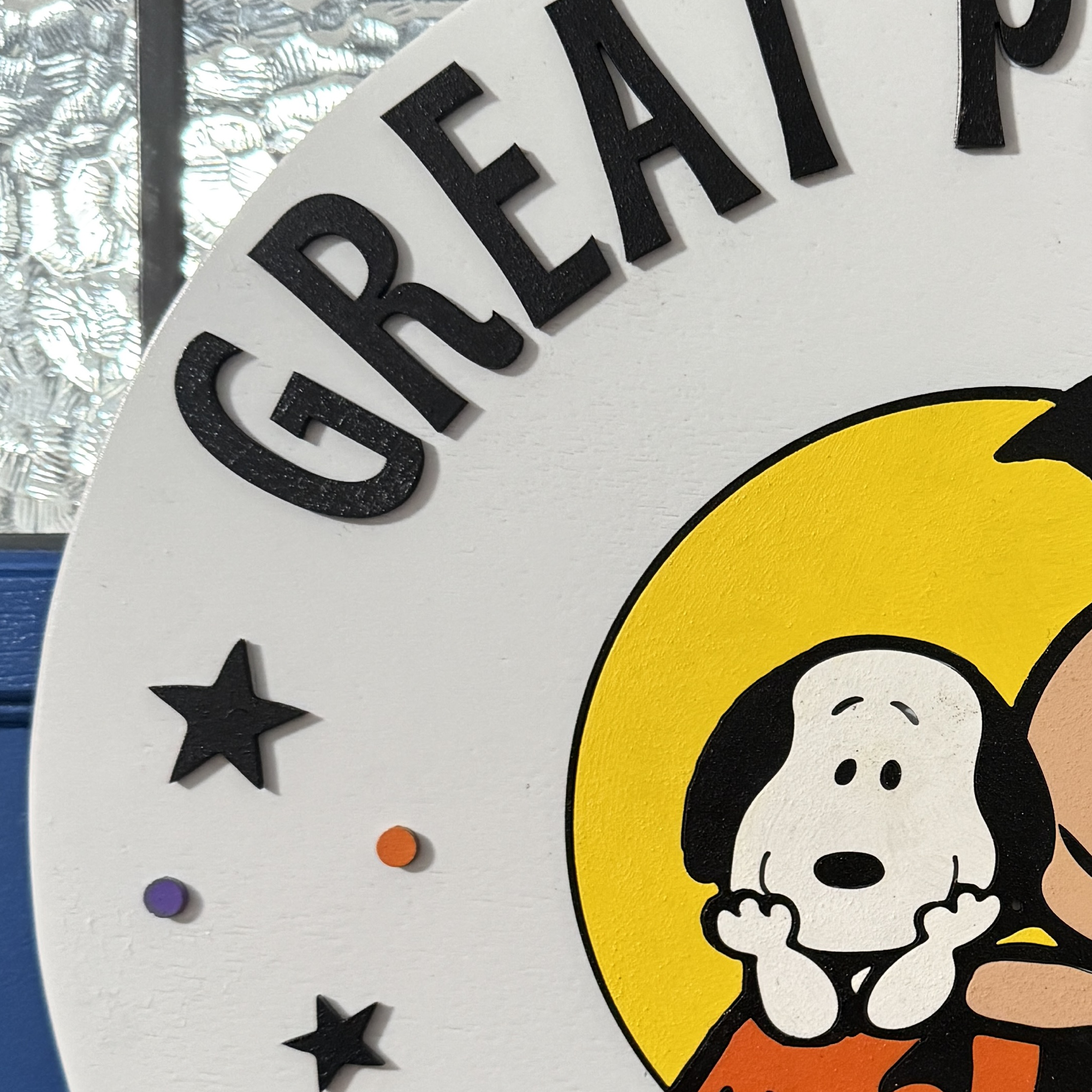 Close-up of Halloween door hanger highlighting hand-painted characters and pumpkin details