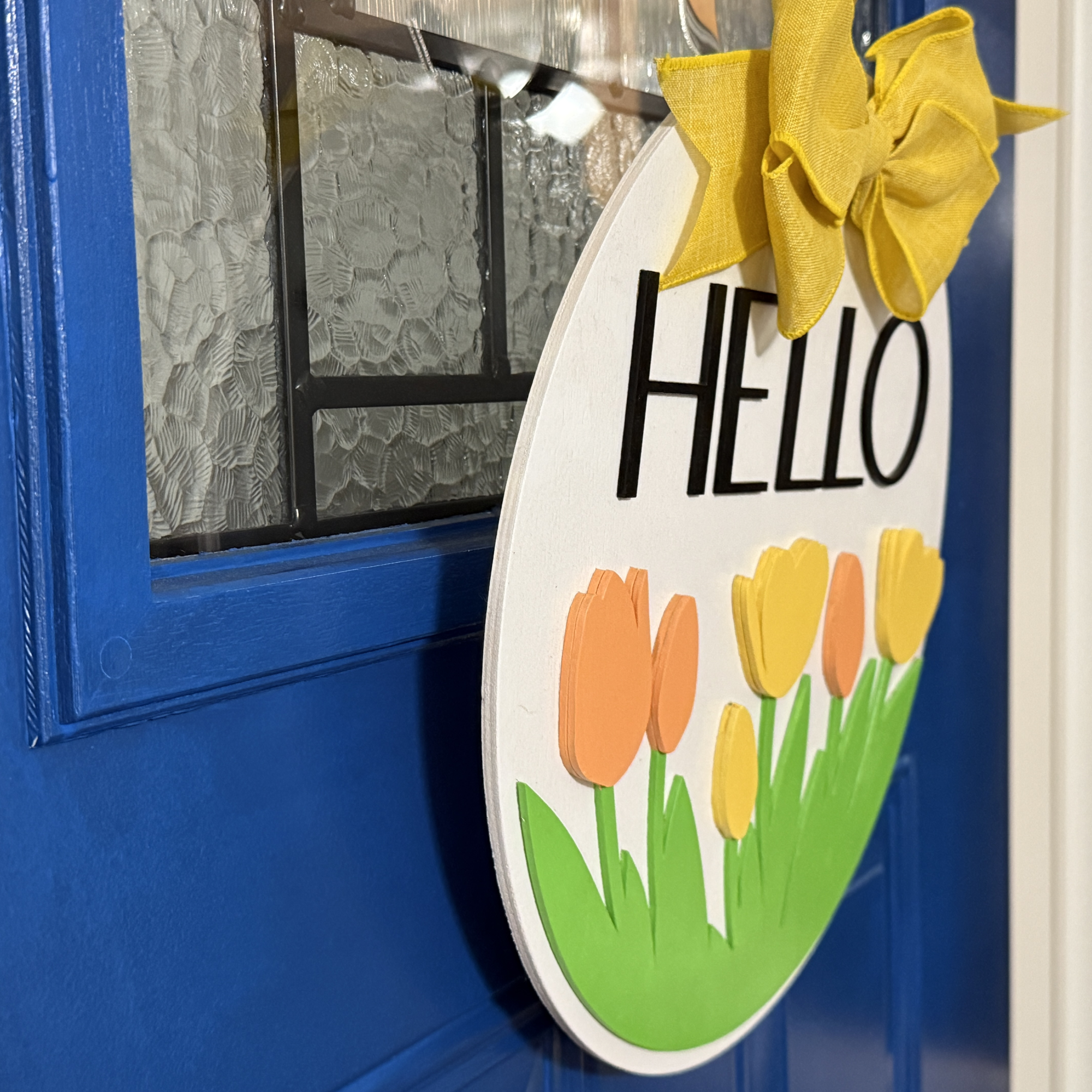 Hello Spring door hanger, side view, showing base thickness and layered wood details