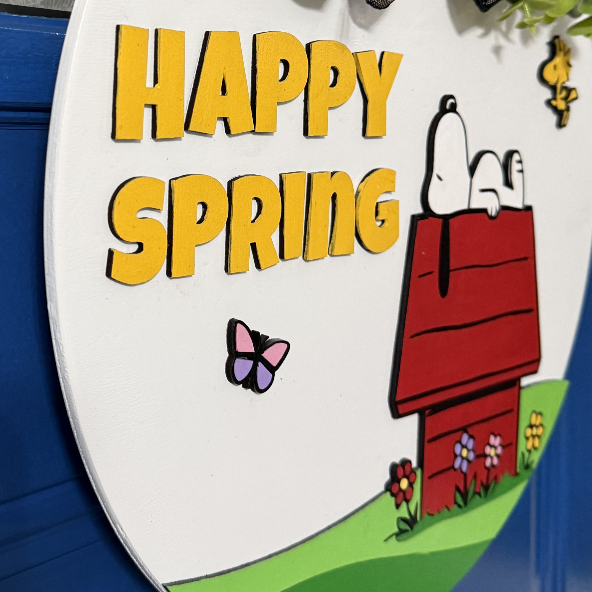 Side angle of sign showing dimensional layers and painted wood construction