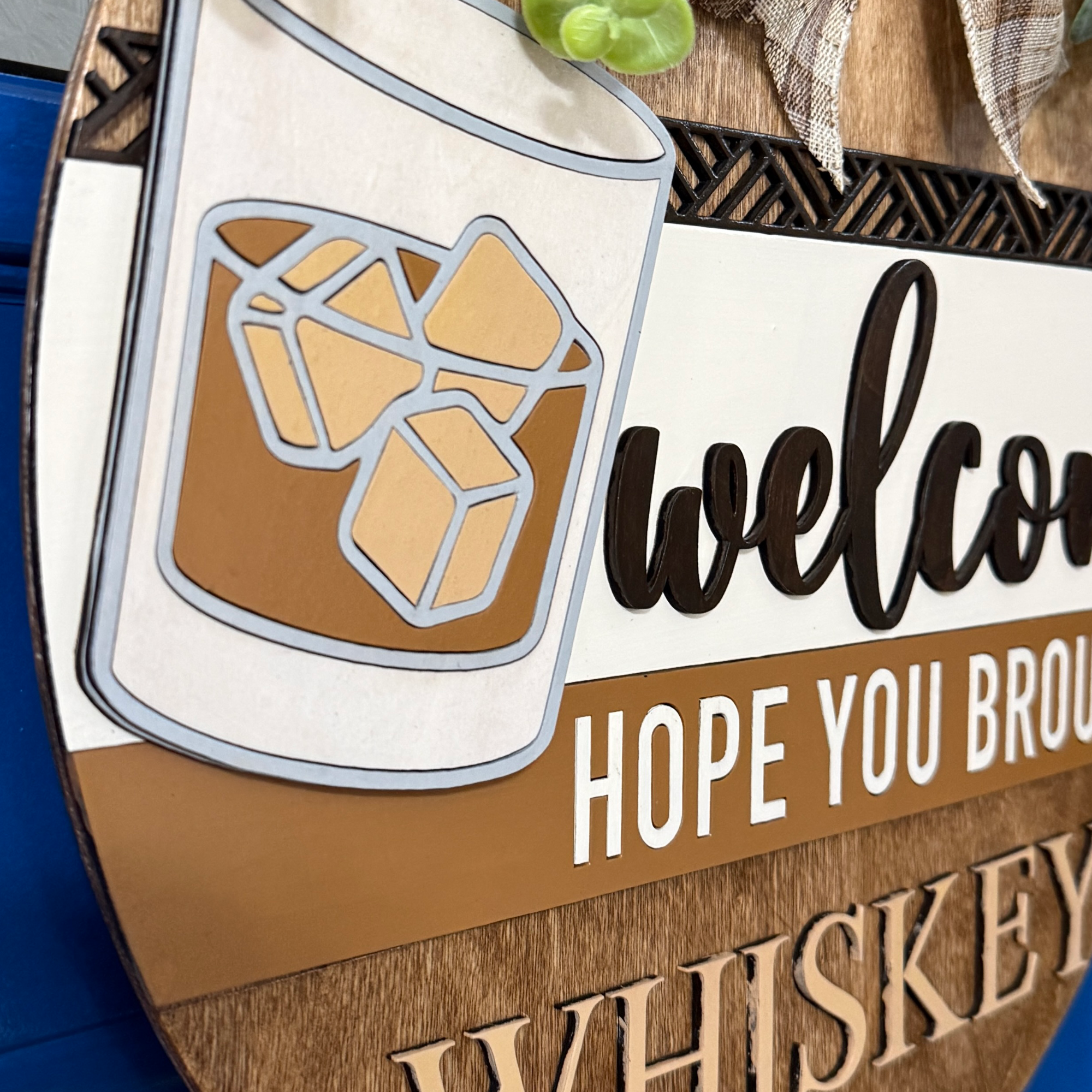 Close-up of large “WHISKEY” lettering carved into lower wood section