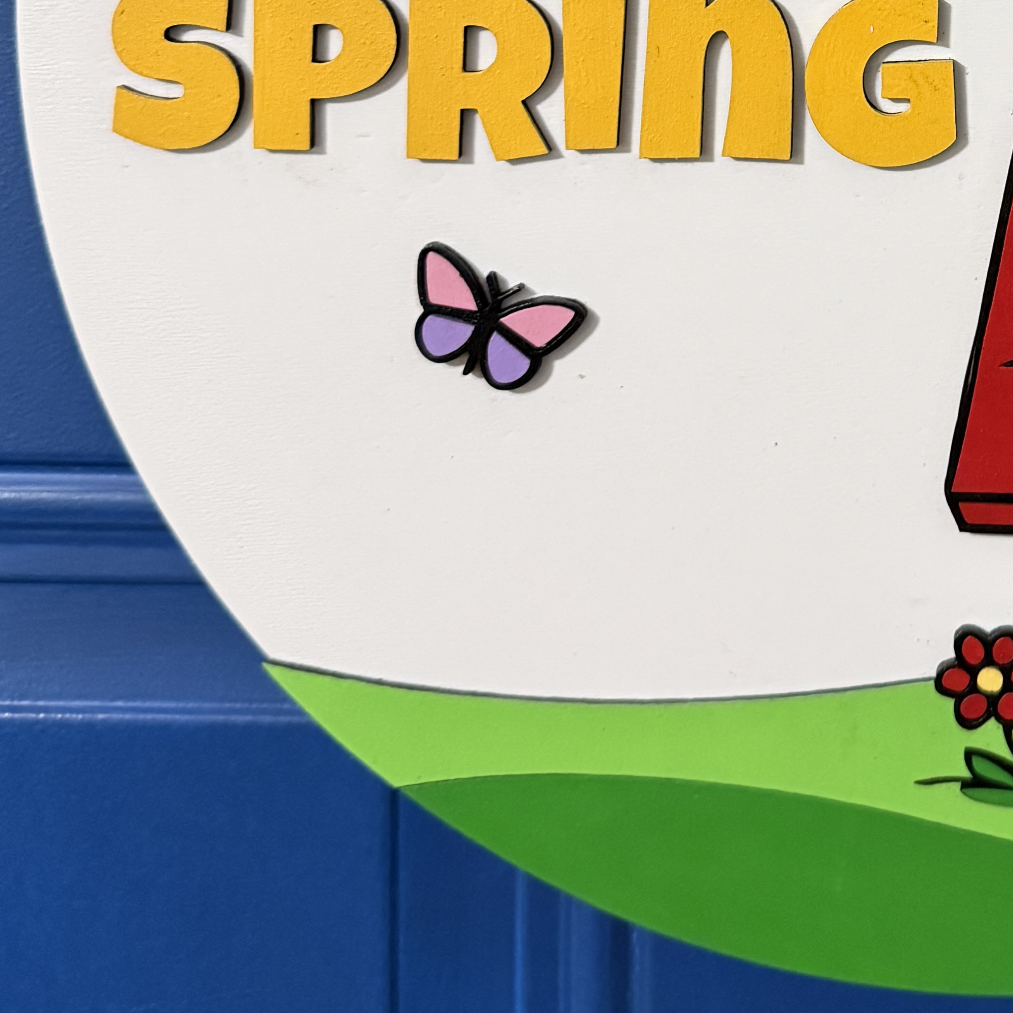 Close-up of Woodstock character detail hanging near top of sign