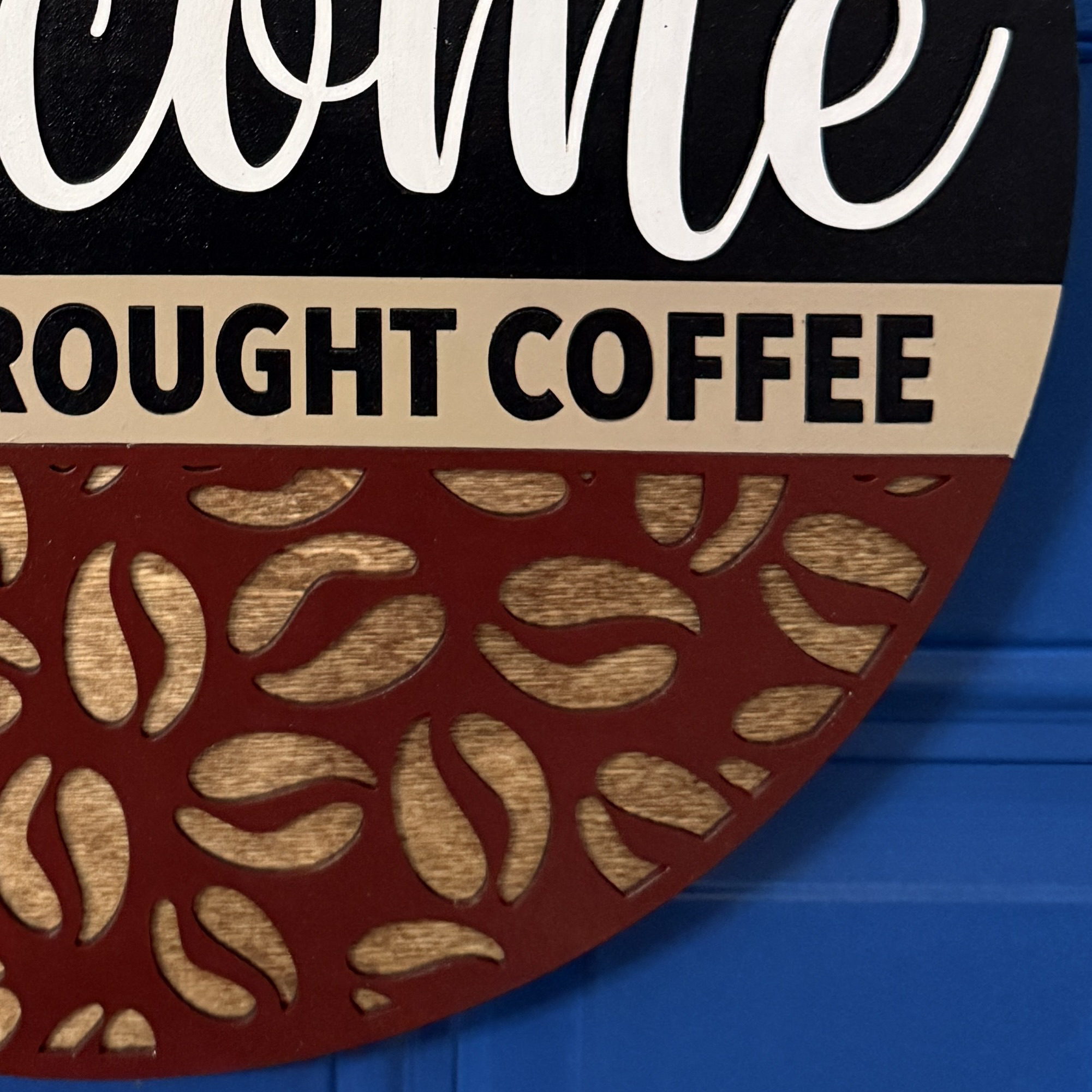 Partial crop of welcome lettering showing bold white script on black background