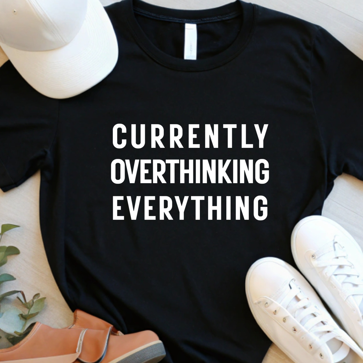 Flat lay of black unisex t shirt with currently overthinking everything text