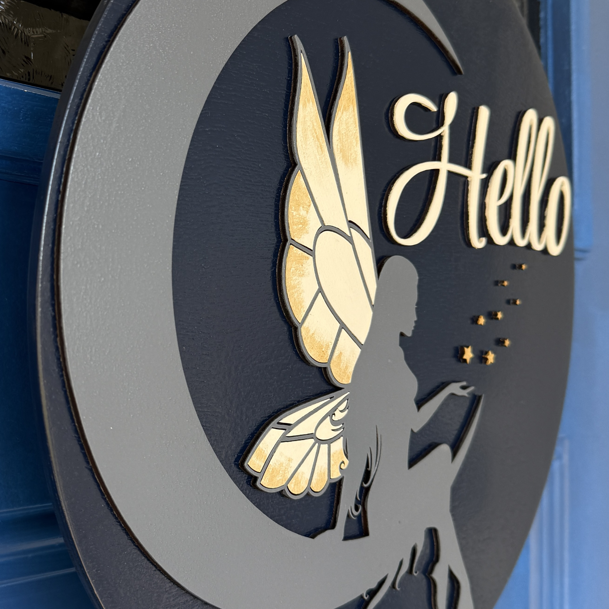 Side profile of 1/4 inch thick layered wood fairy moon door hanger showing depth and dimension