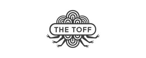 Black and white logo with ornate design and the text 'The Top' in the center.