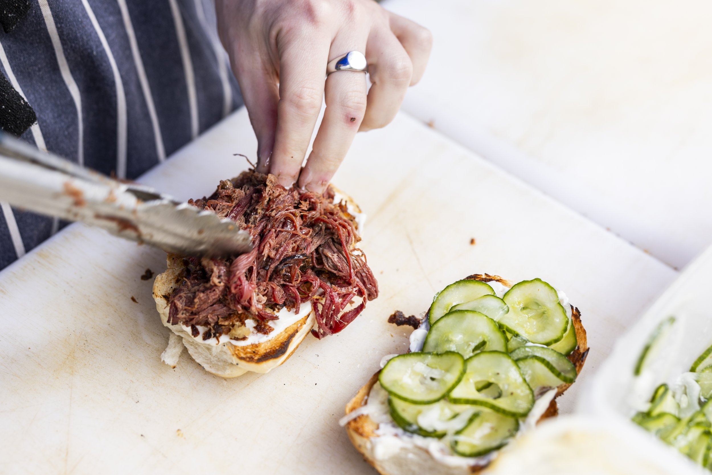 Sarnie Party 2024 Ruben assembling BBQ Pastrami Challah.JPG
