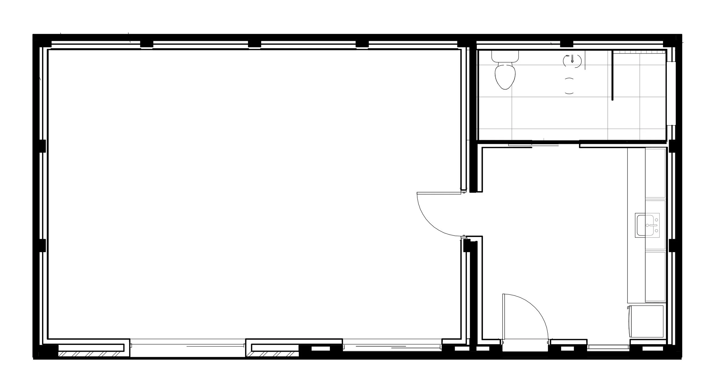 Floor plan of the garage conversion, with the existing brick walls in solid black and the new lined studio, kitchenette and bathroom inside.
