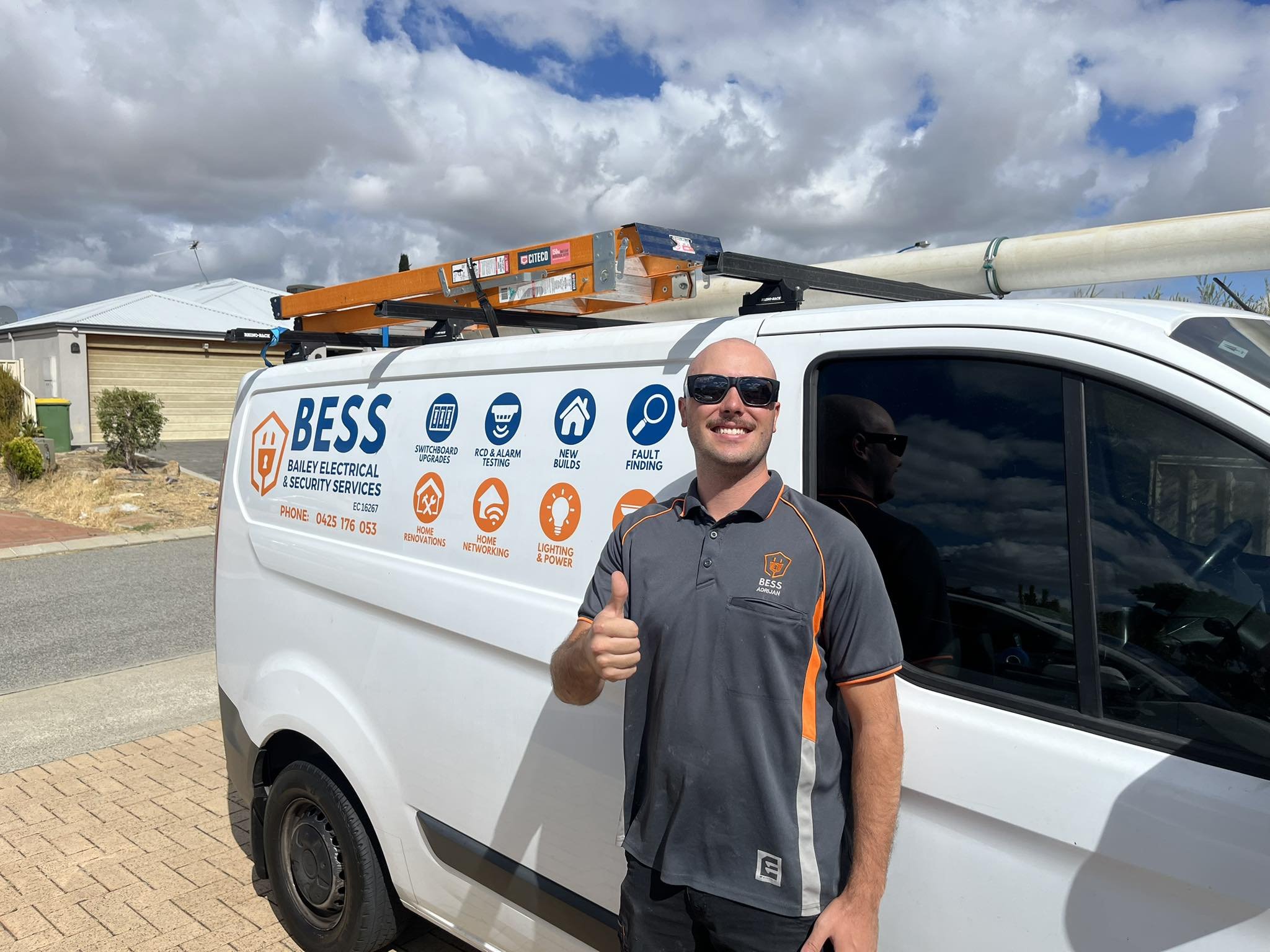 BESS electrician beside Bailey Electrical and Security Services van
