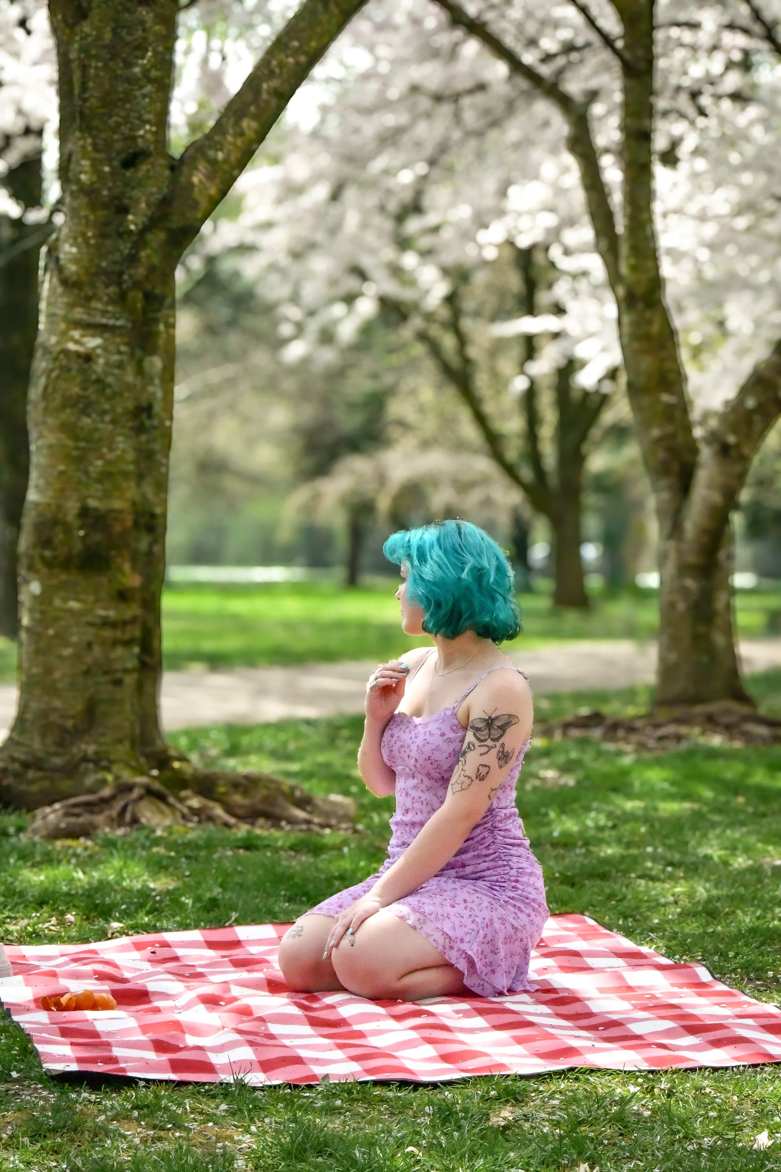 Headshot photographer with a cherry blossom background makes for dainty and beautiful photos
