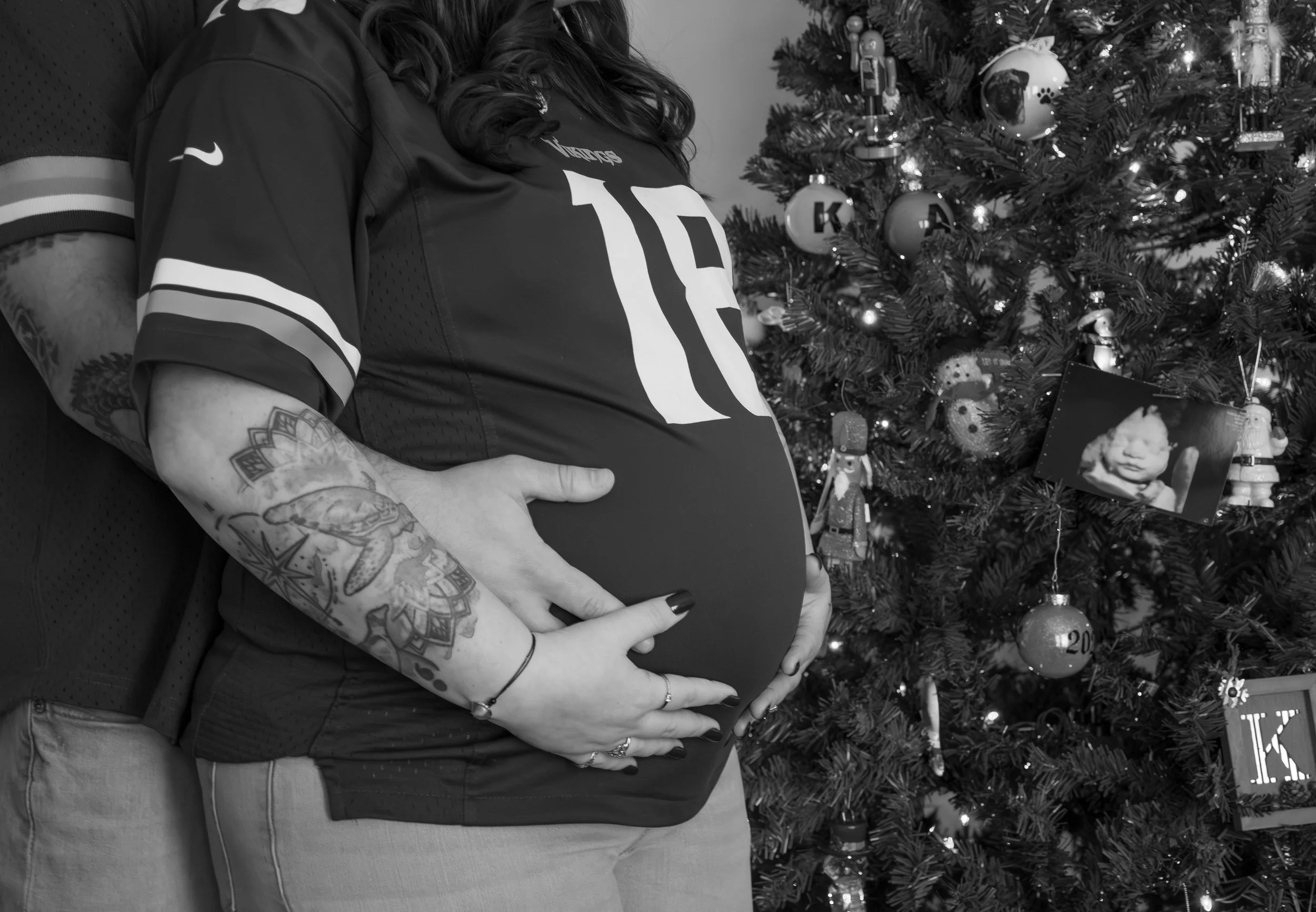 Football lovers and Christmas time maternity photos in black and white - subtle but sweet