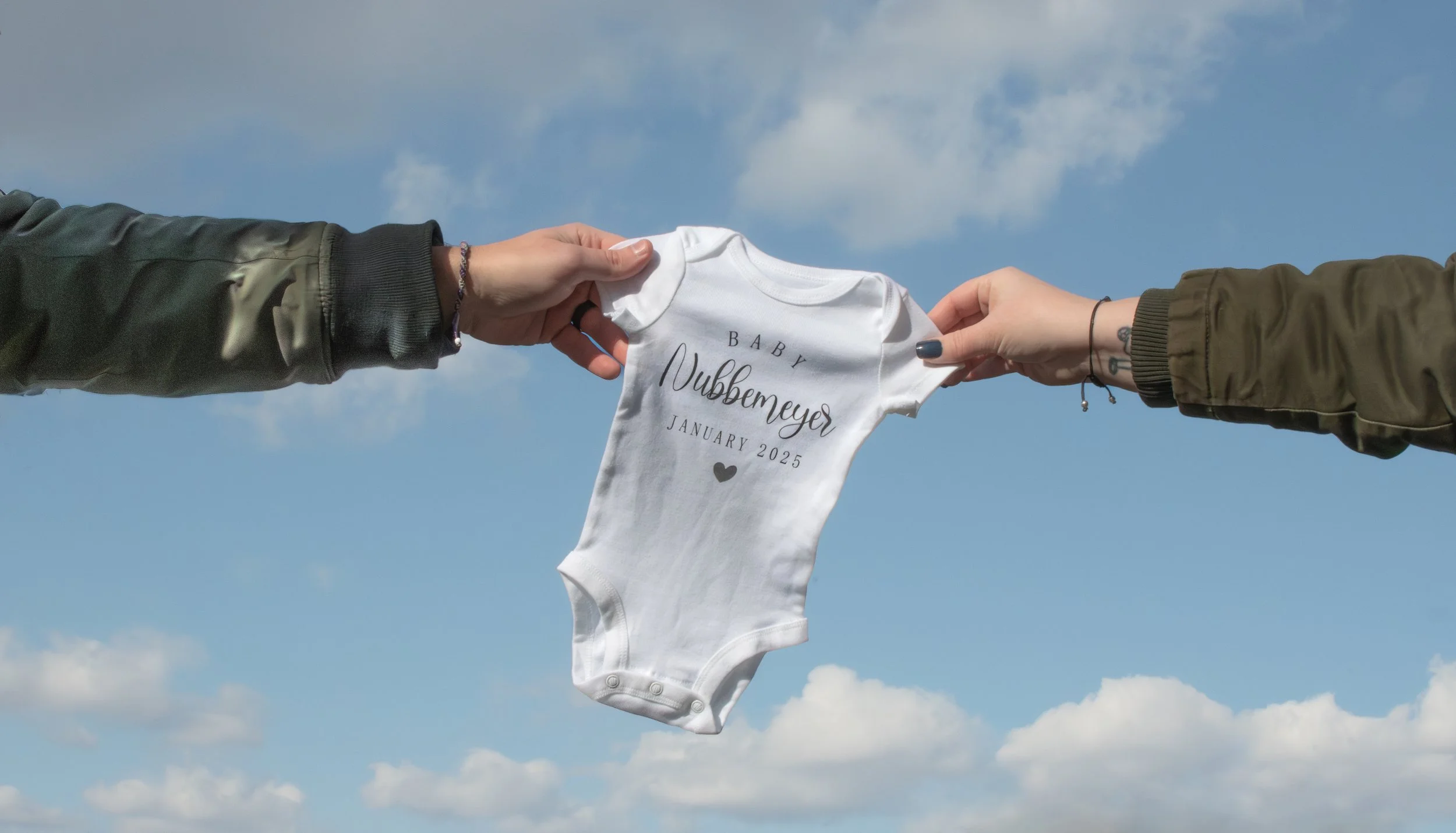 Two hearts soon to be three - Creative onesie maternity photo