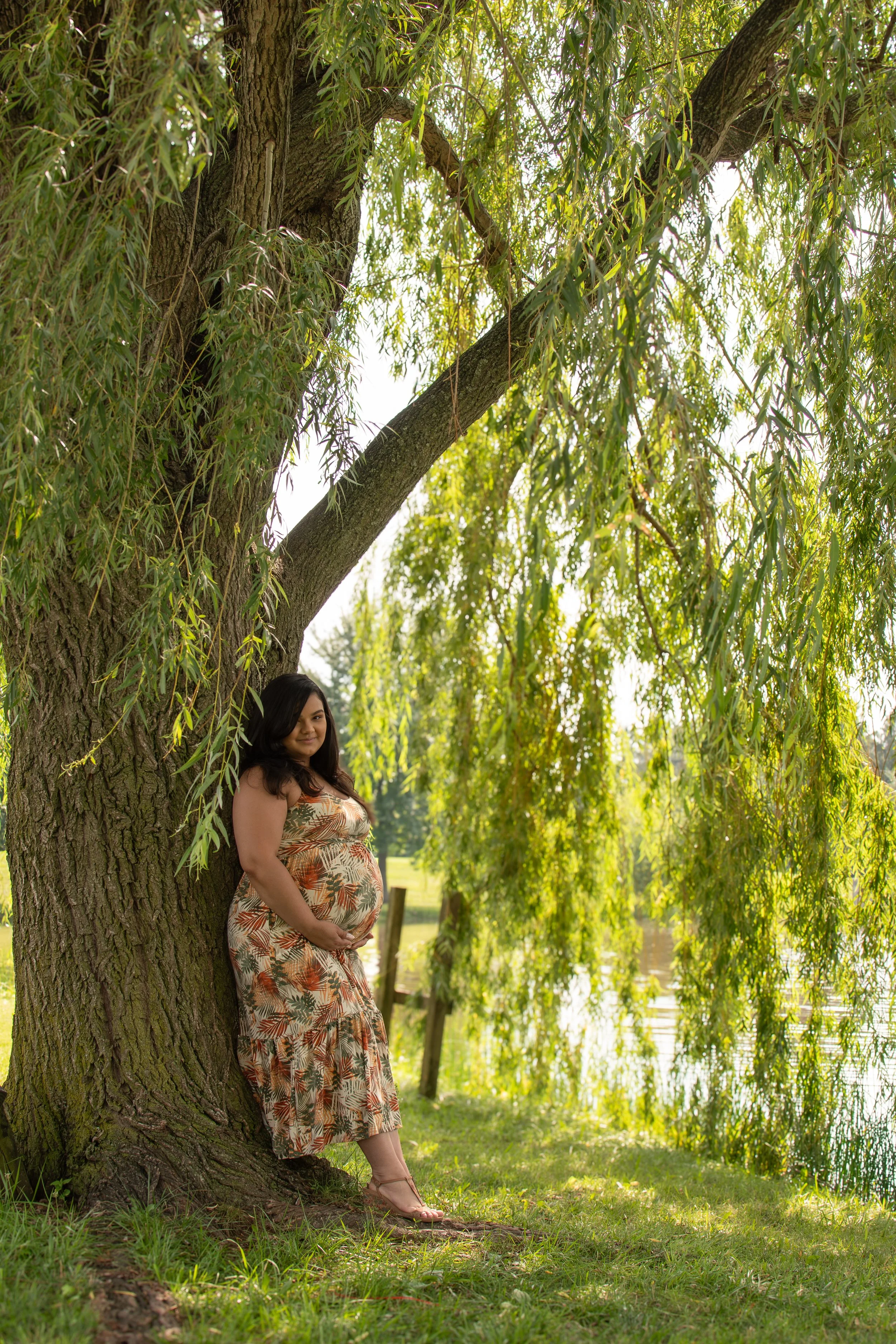 Maternity session under a willow tree, connected to earth as the world awaits the arrival of a new addition to the family