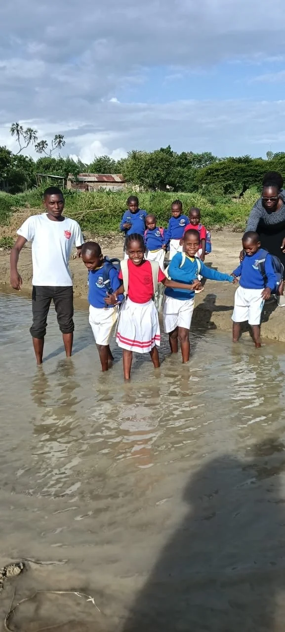 Mr. Francis helping older learners through water.