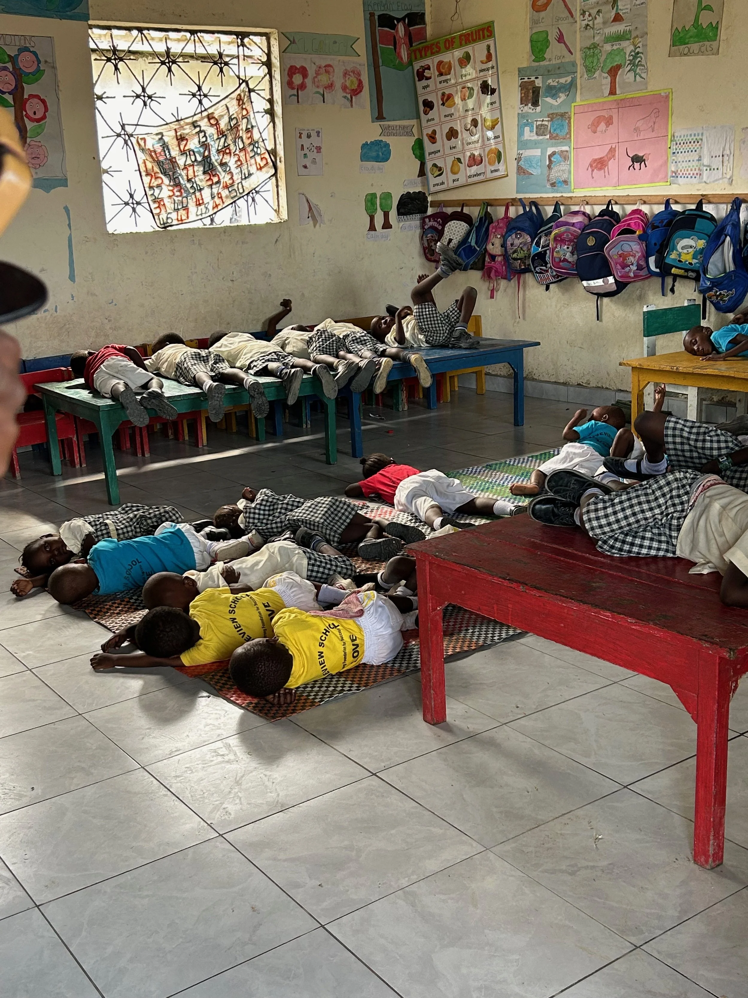 Baby class napping on floor and table tops
