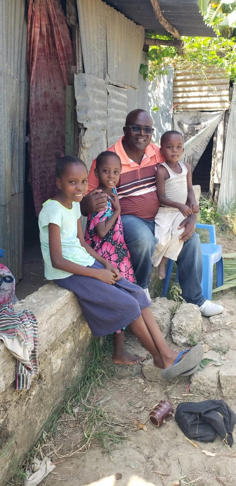Aisha at home with Ken and family.