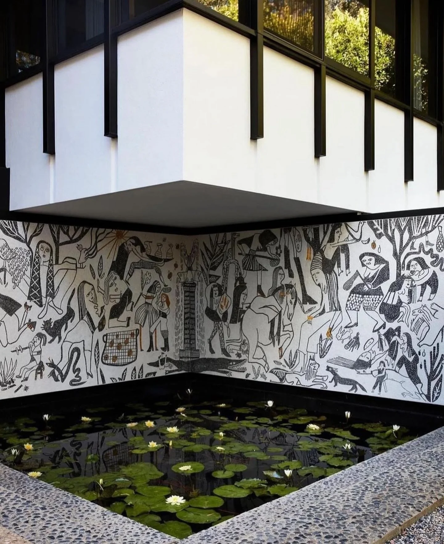 A courtyard mural and reflecting pool create a cinematic stillness. Art, architecture, and landscape merge into one continuous story.