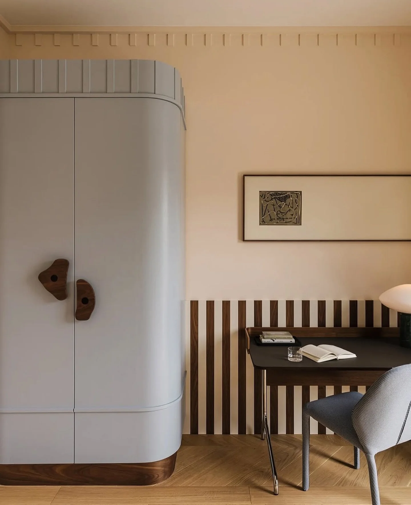 I love when joinery becomes art. The curved cabinetry and vertical wood detailing turn this small moment into a full design statement.