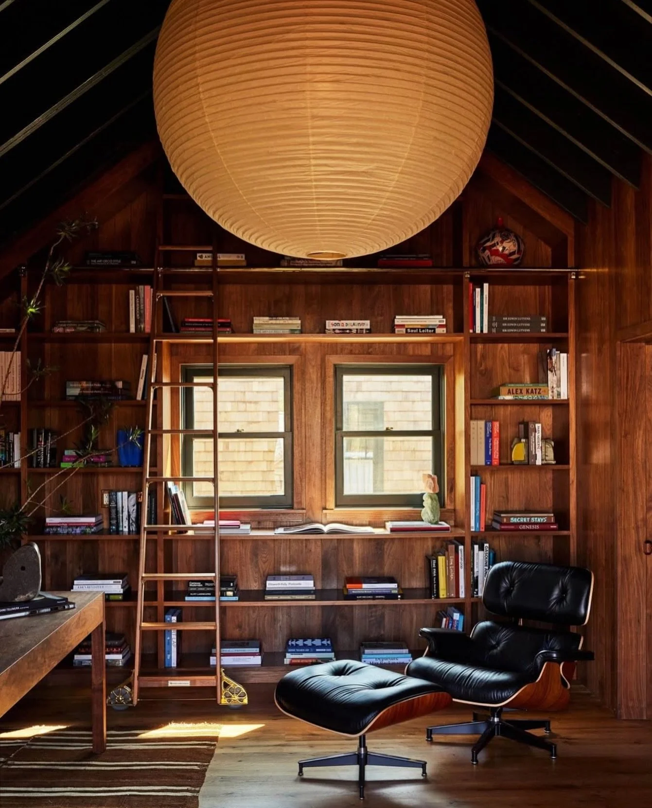 A cocoon of wood, books, and light. The kind of room that holds quiet conversations. 

Design by @electricbowery