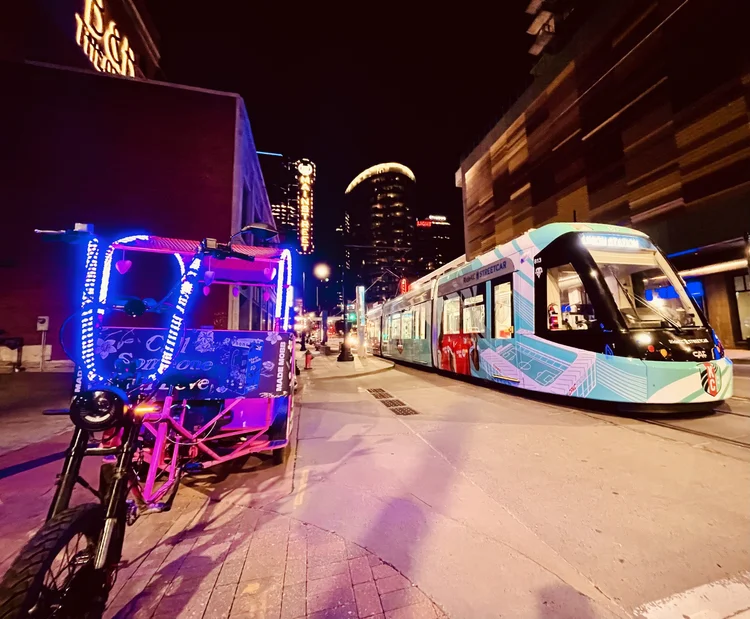 A pedicab driver and passengers in downtown KC