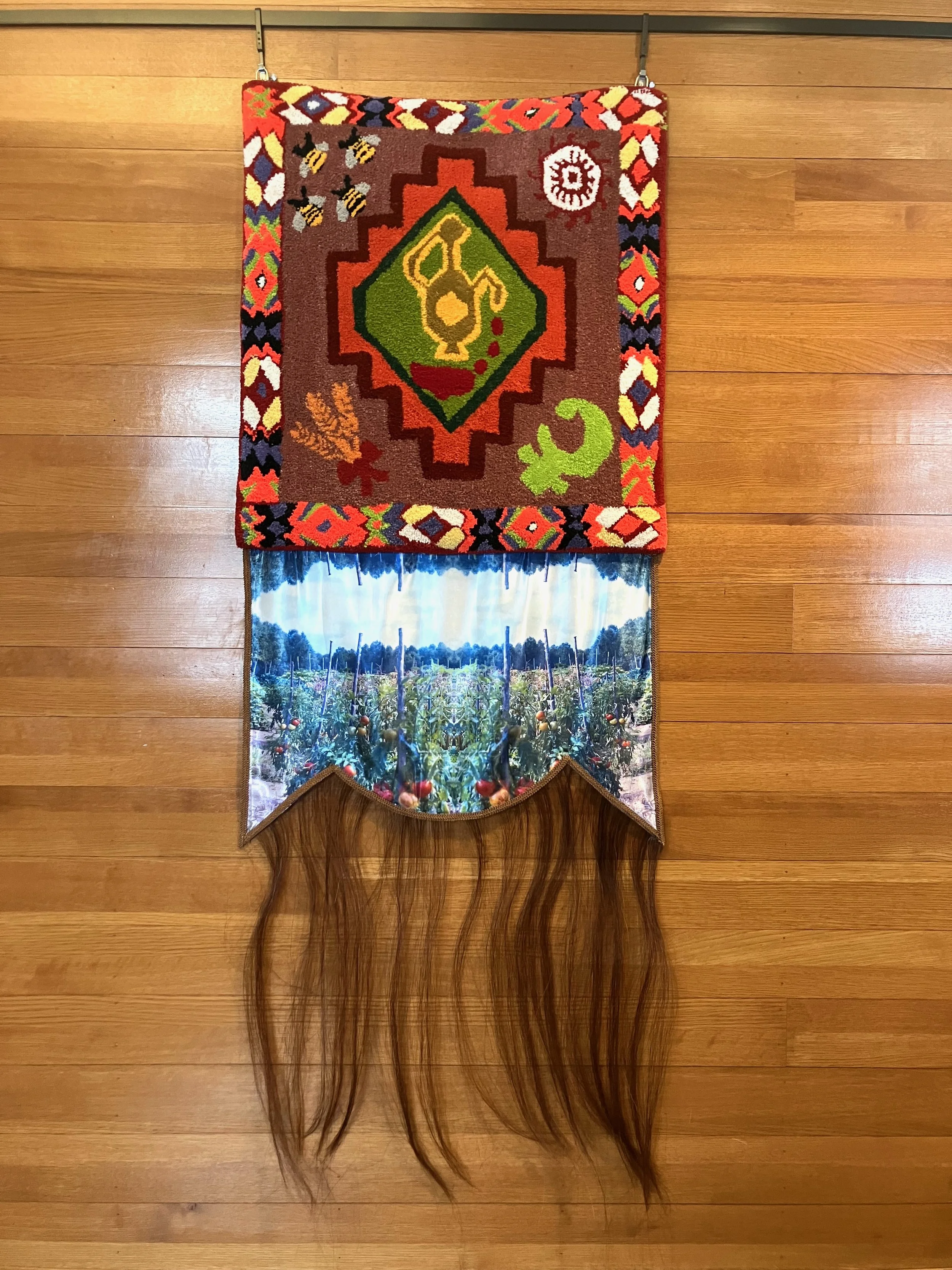 Lammas
May we create with the earth and spirit with pleasure.

Machine tufted wool, my great-grandpa Constantine’s photo of his tomato garden on satin, horse hair, gimp trim, glue, backing, hooks
