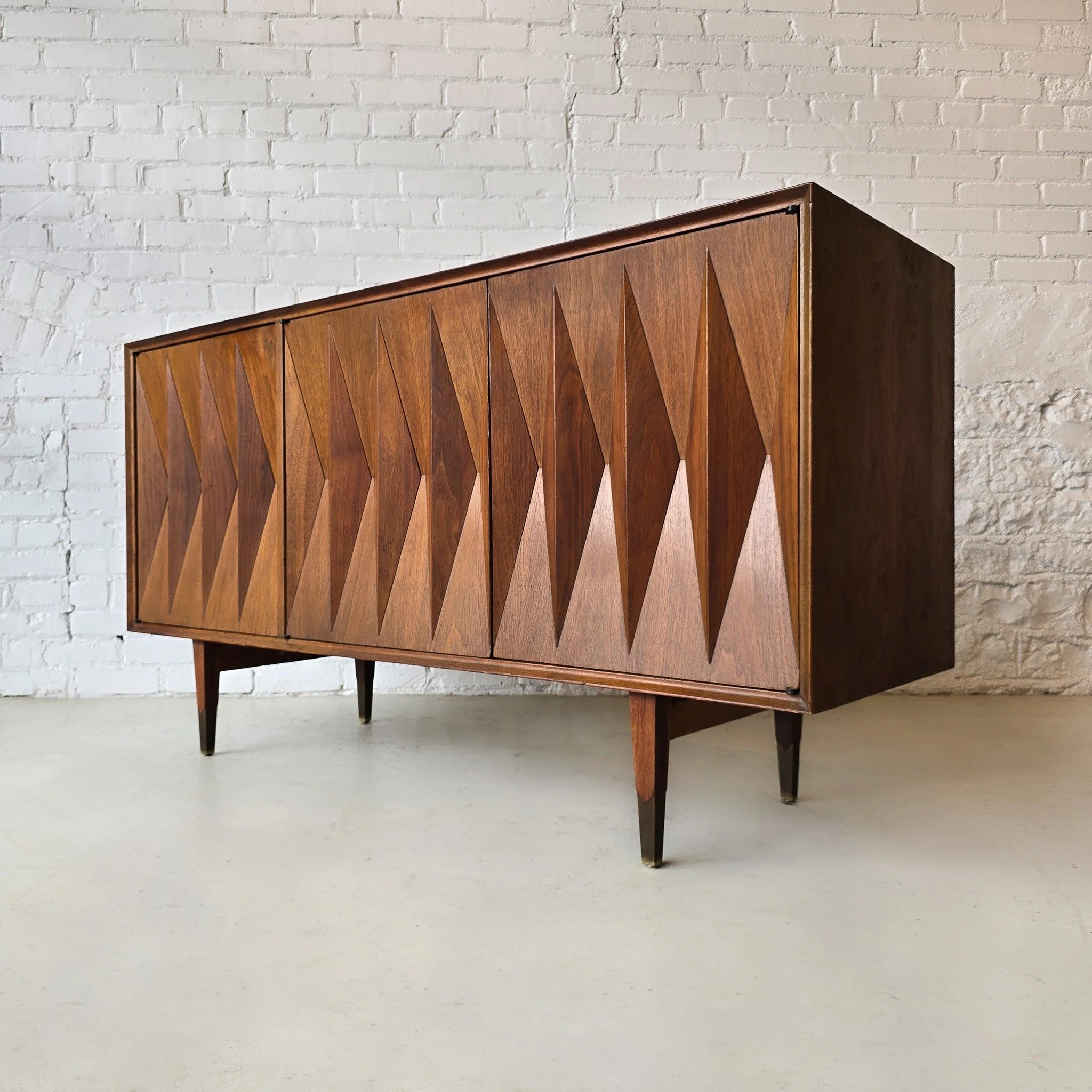 Designed by Albert Parvin for American of Martinsville this instantly recognizable piece of mid-century design is a truly rare beauty. Sourcing these is a hard enough, but a three door credenza? Almost impossible! Add an instant touch of Mad Men-esqu