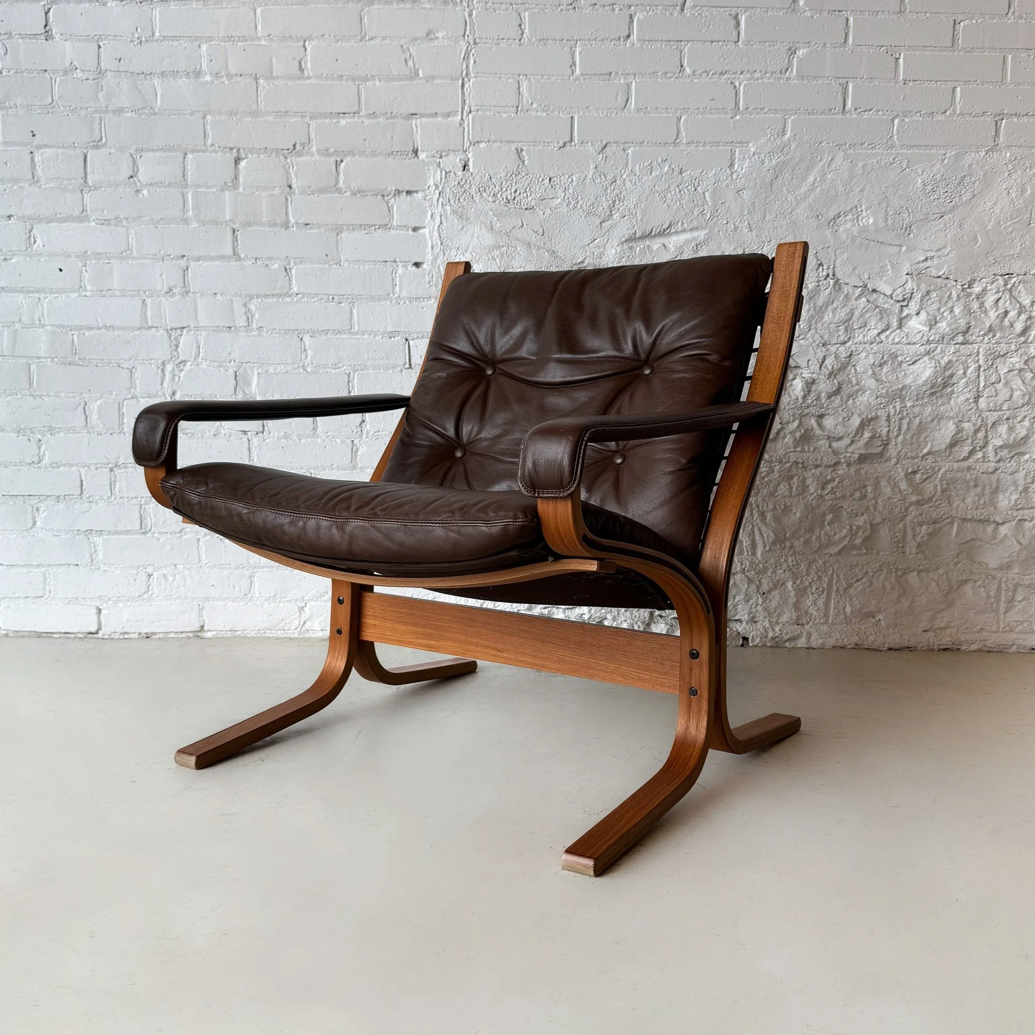 The Siesta chair by Igmar Relling: This piece is the statement chair to end all statement chairs. The design features a teak bentwood frame, stitched canvas sling back, and supple brown leather cushions and armrests. If that wasn't enough, she's extr