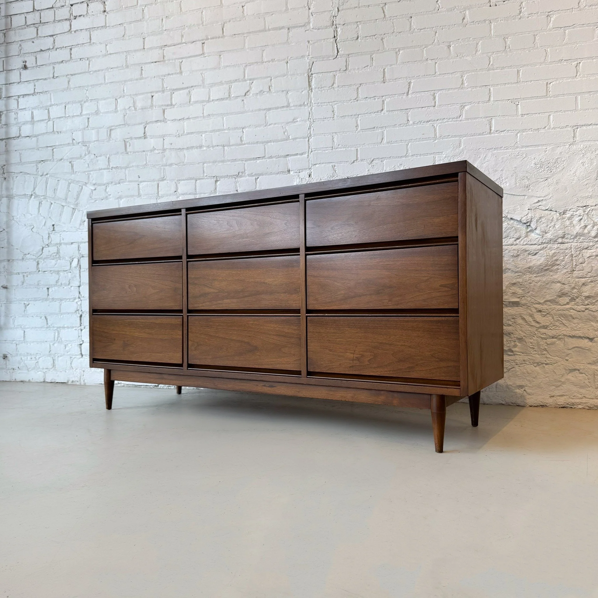 Nothing makes folding laundry fun quite like putting it away in a beautiful mid-century dresser. This Pacemaker piece has nine roomy drawers for optimal organization and integral pulls for a minimalist exterior. This piece has some small signs of wea