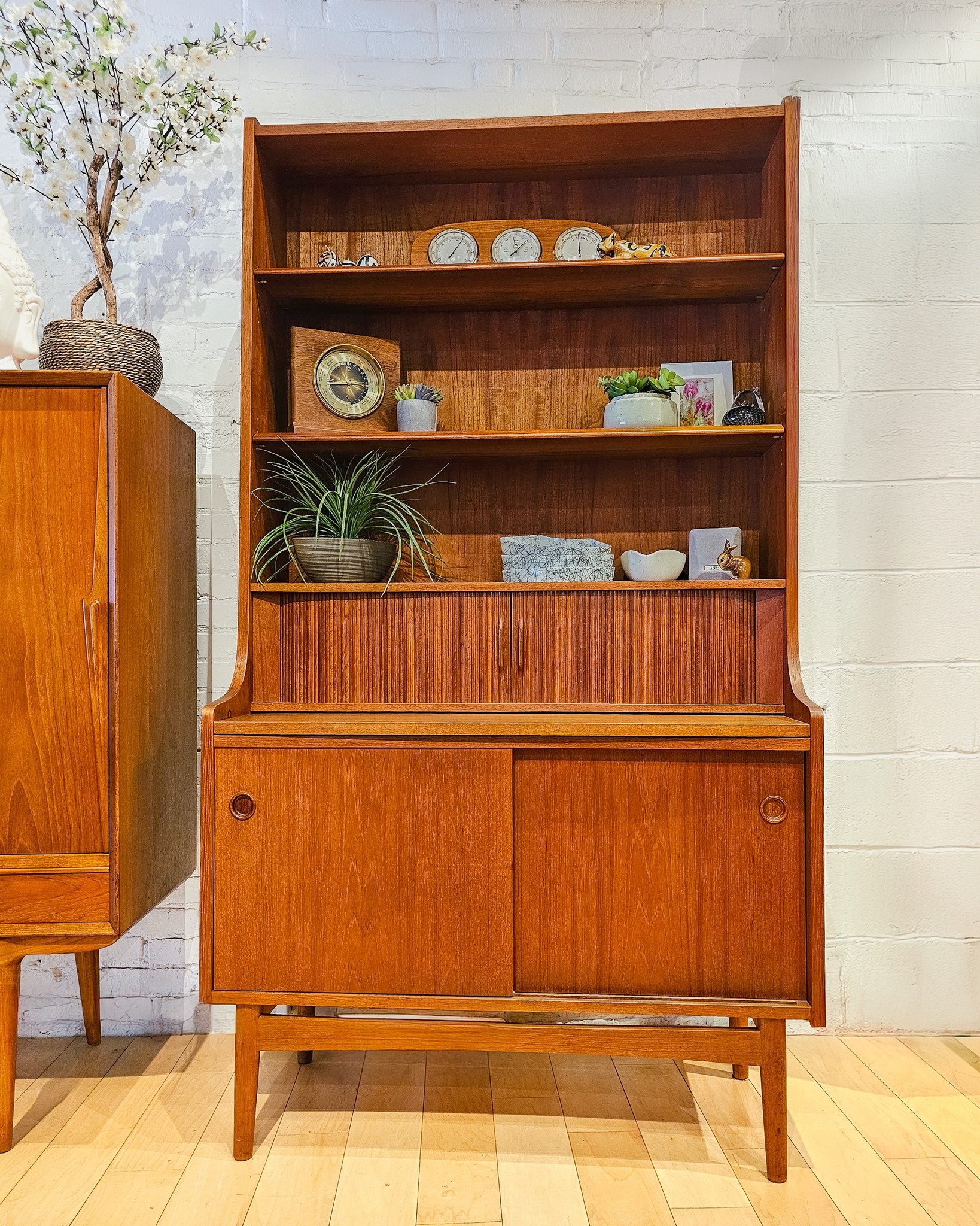 SHOWROOM SALE // Day 2
Ready for a multitasking mid-century moment? Today’s sale spotlight is doing the absolute most (and looking good while doing it).
Meet the Johannes Sorth Teak Bookcase
Don’t be fooled by its sleek profile—thi