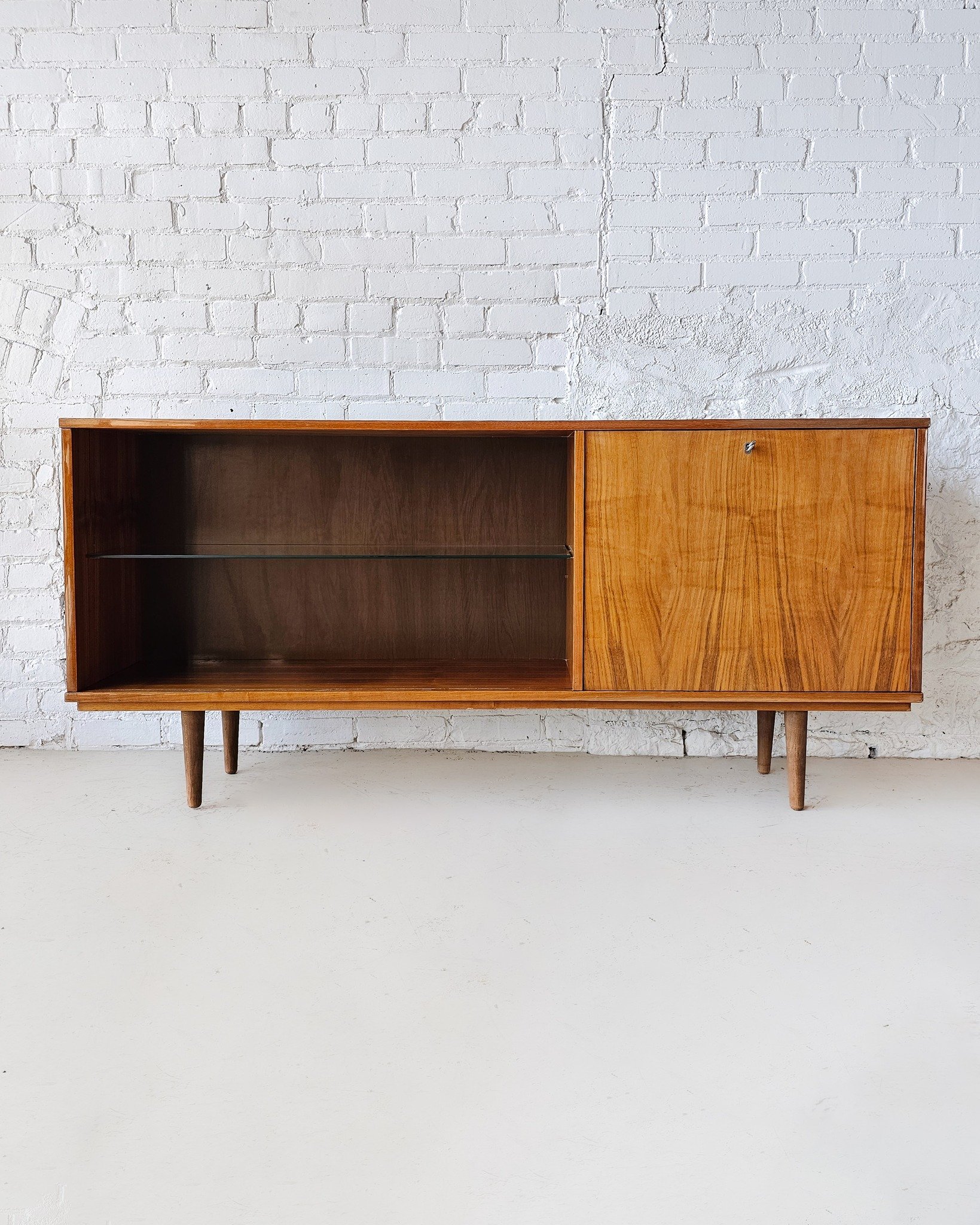 This low-profile walnut sideboard is your new go-to for hosting, storing, and showing off. With its rich, medium-toned walnut grain and clean lines, it fits seamlessly into almost any design style—from cozy and eclectic to sleek and modern.
A