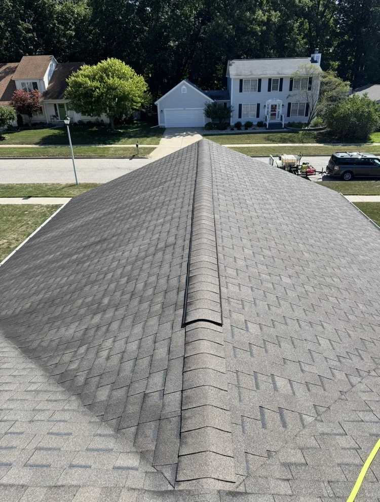 Residential roof cleaning service in Haslett MI showing asphalt shingle roof after professional soft washing.