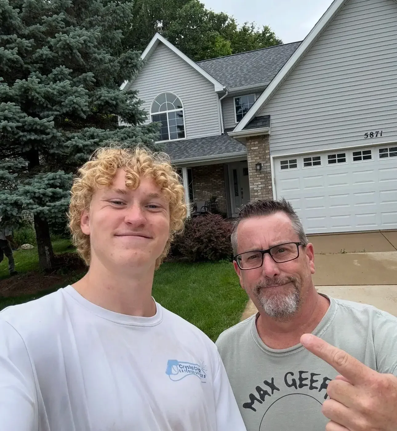 rystal Clear Exterior Services team member with satisfied homeowner after house washing service in Haslett MI