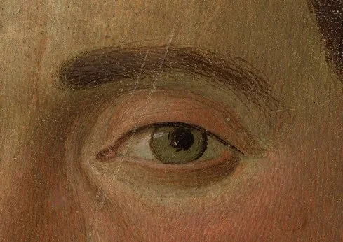 Close-up of a human eye and eyebrow on a painted portrait.