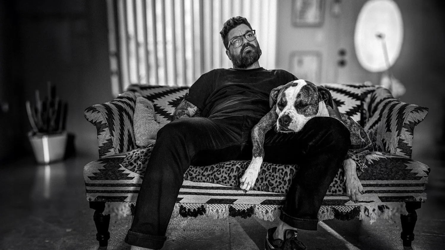 Kurt William, graphic designer in Orange NSW, sitting on a sofa with his dog