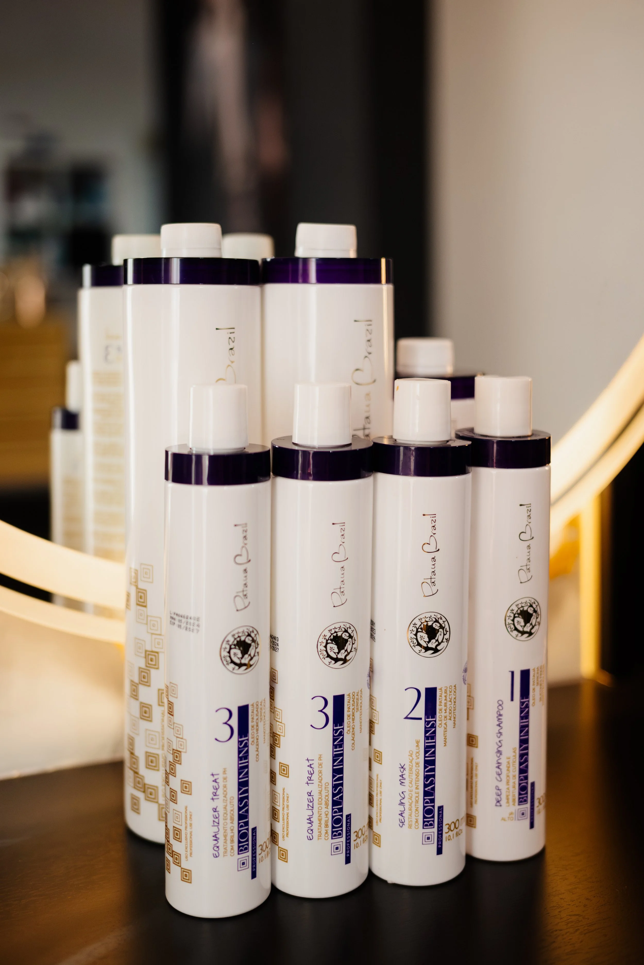 Several bottles of BioPlastia Intensive hair care products arranged on a table.