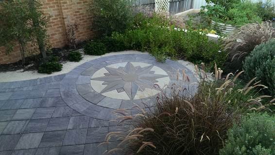 AFTER: Full design: Country Earth's feature paving creates a small and cozy spaces, surrounded by abundant and layered plantings