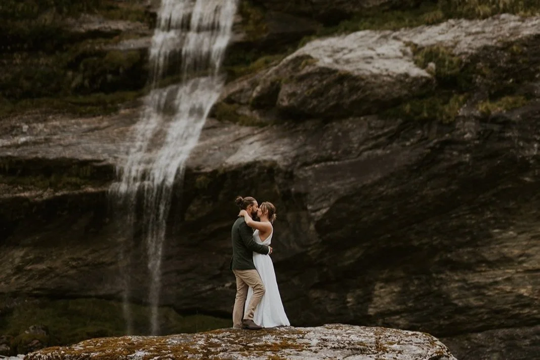 Bride and groom by a waterfall