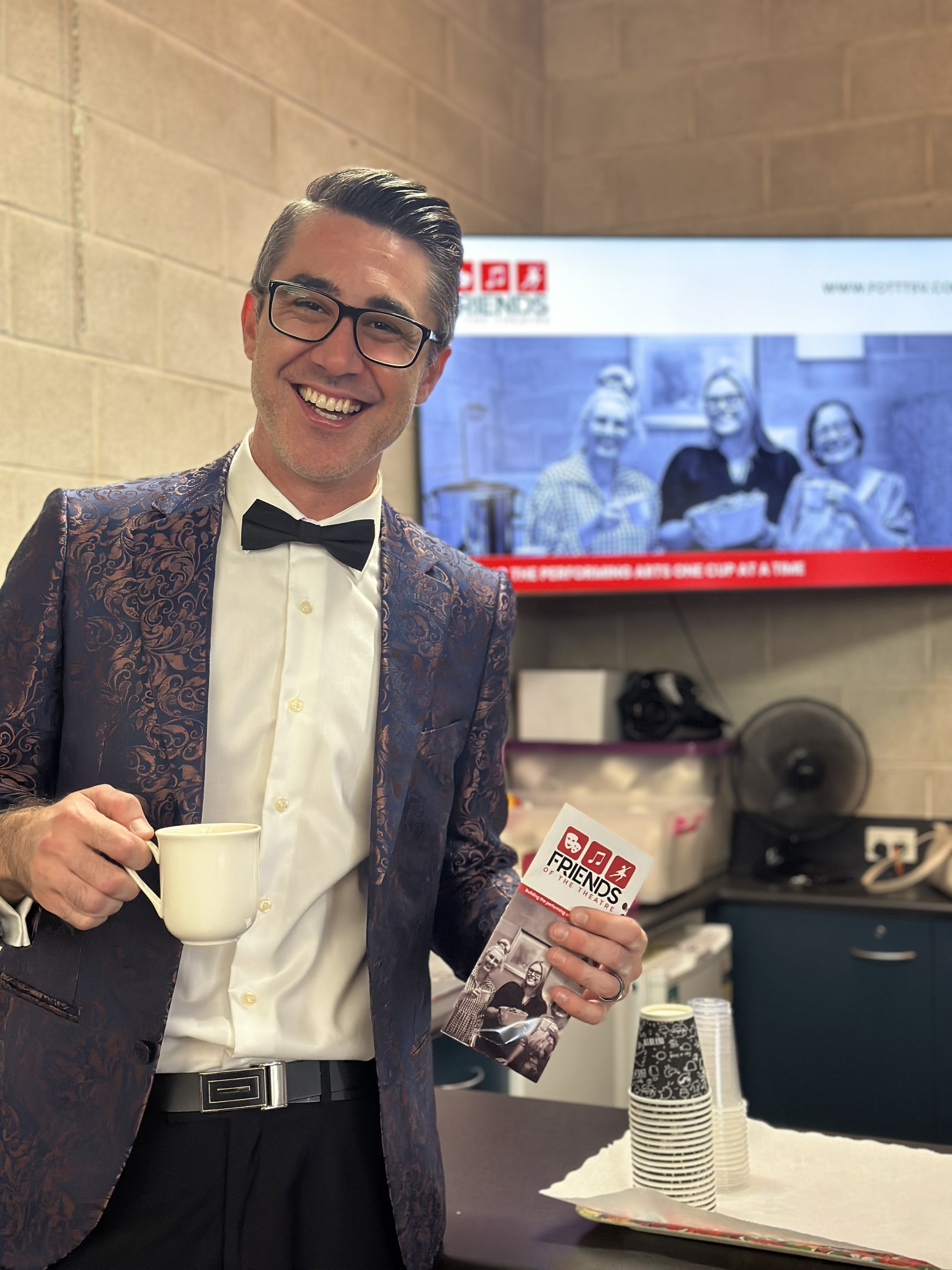 Councillor Liam Mooney enjoying a cuppa at the opening night of the North Queensland Eisteddfod 2025.