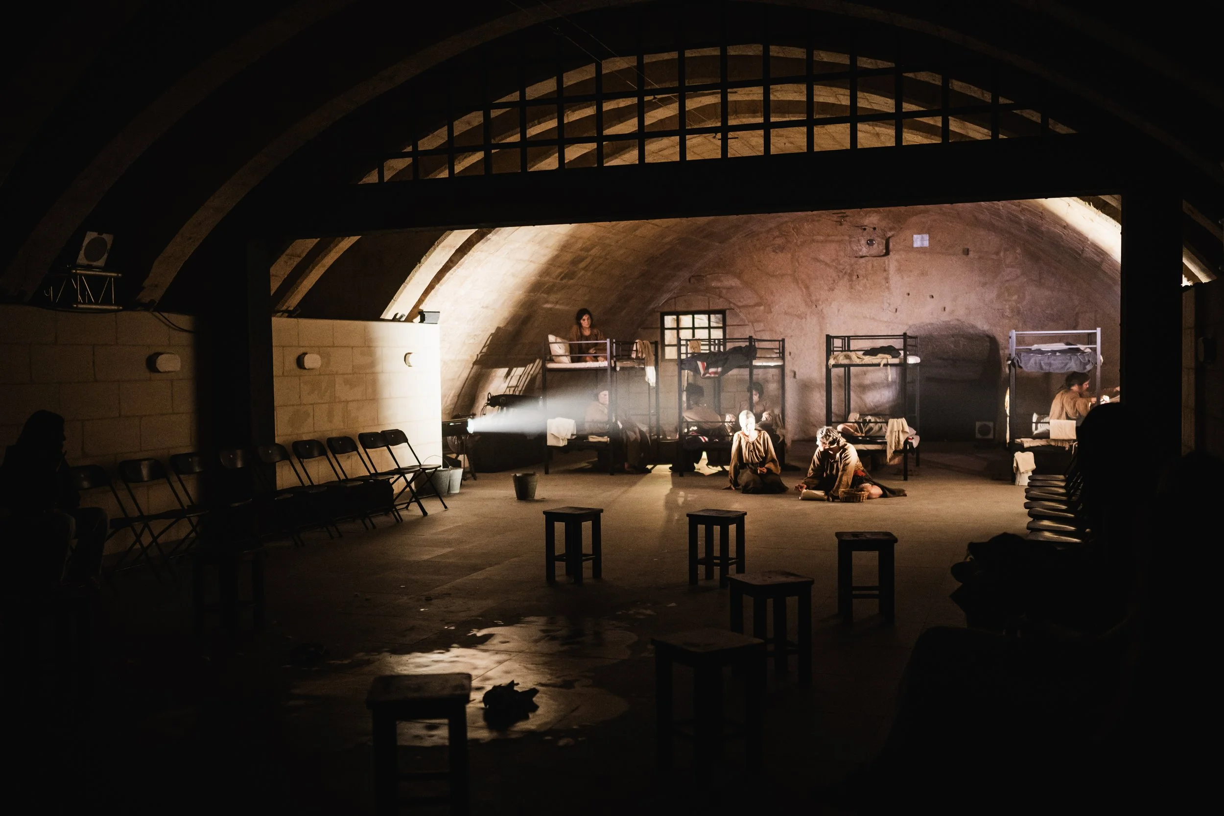 Stage set for Ġimgħa l-Ħabs at the Mediterranean Conference Centre in Valletta, featuring a 7m × 4m gate and prison dormitory designed by Maria Rosa Thornhill.