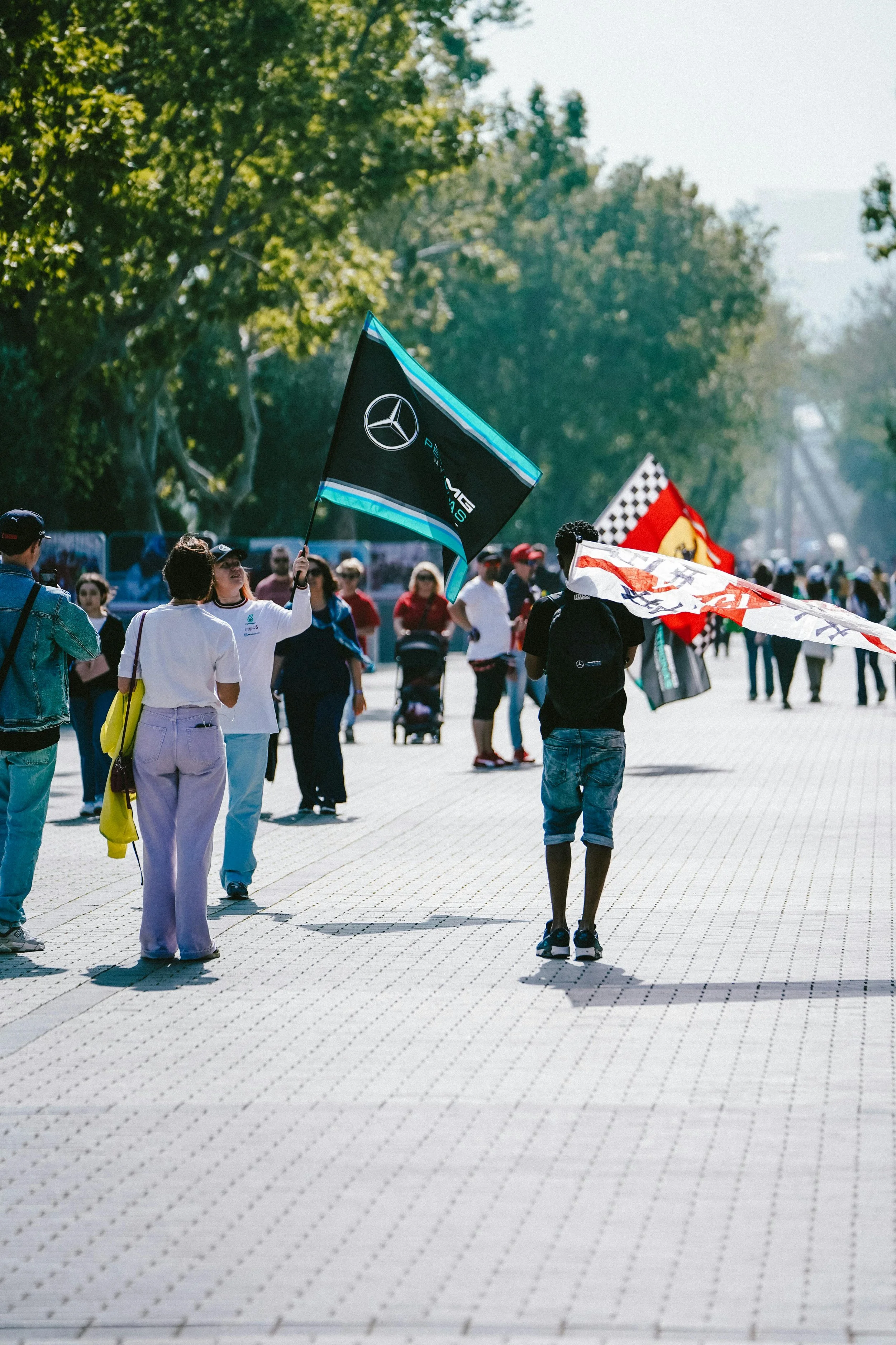 Formula 1 fans walking to race with team flags, showing fan culture and pre-race experience
