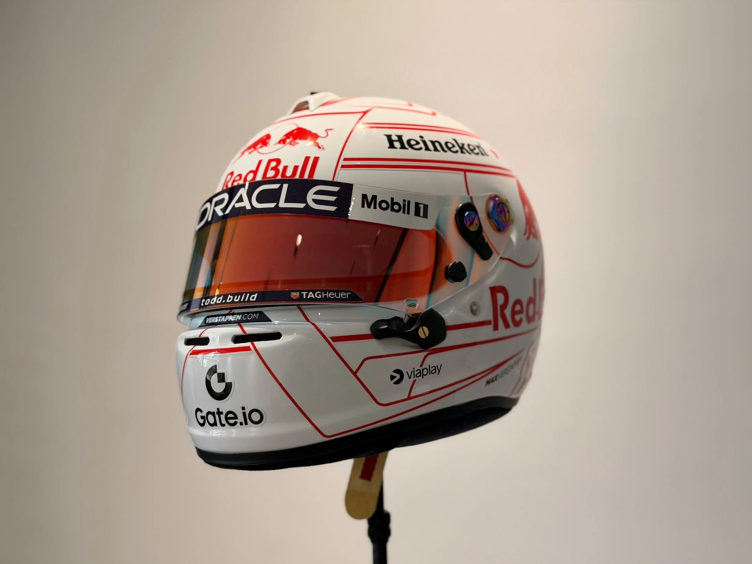 Formula 1 driver helmet featuring multiple sponsor logos