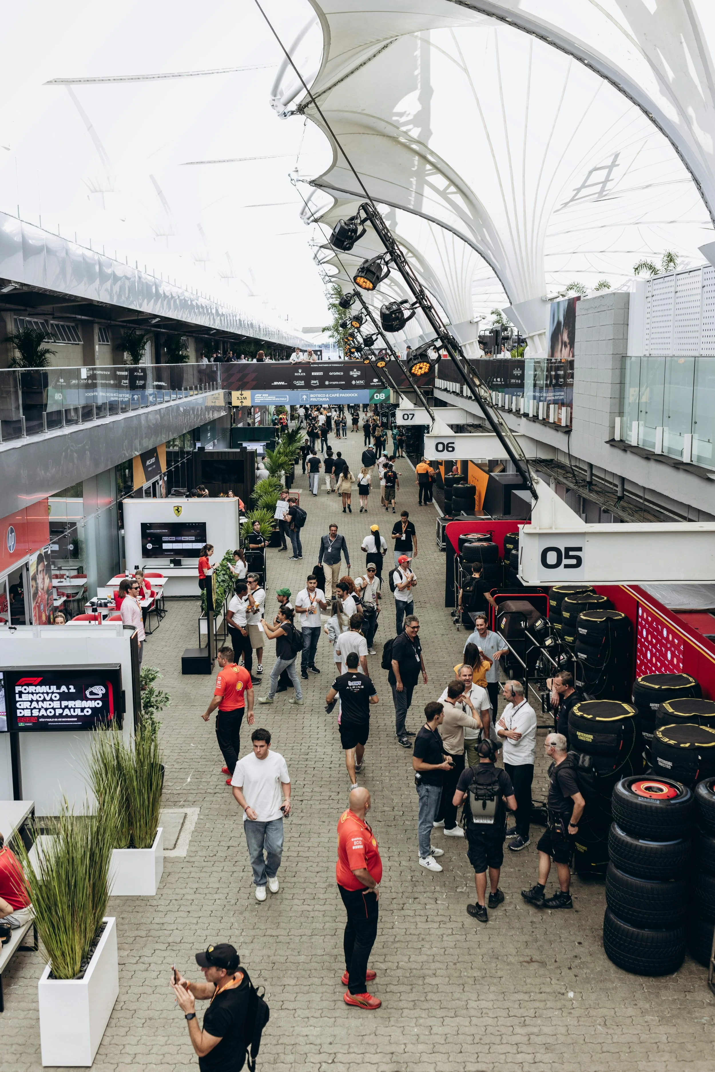 Formula 1 paddock and hospitality area during a race weekend with team members, guests and brand activations