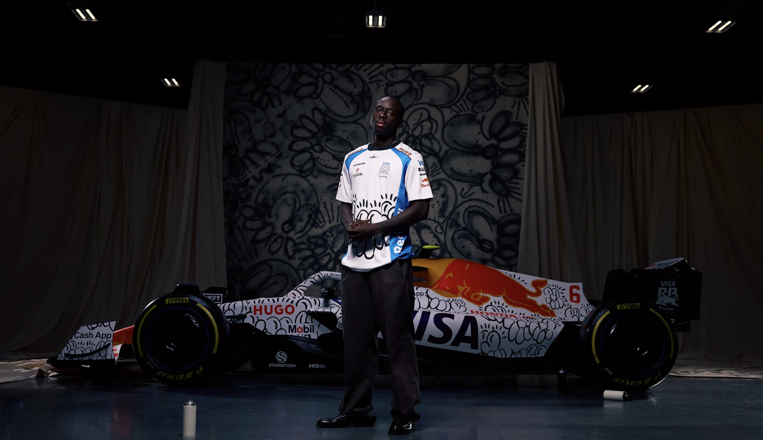 Artist Slawn with the VCARB F1 car featuring his special Silverstone livery design