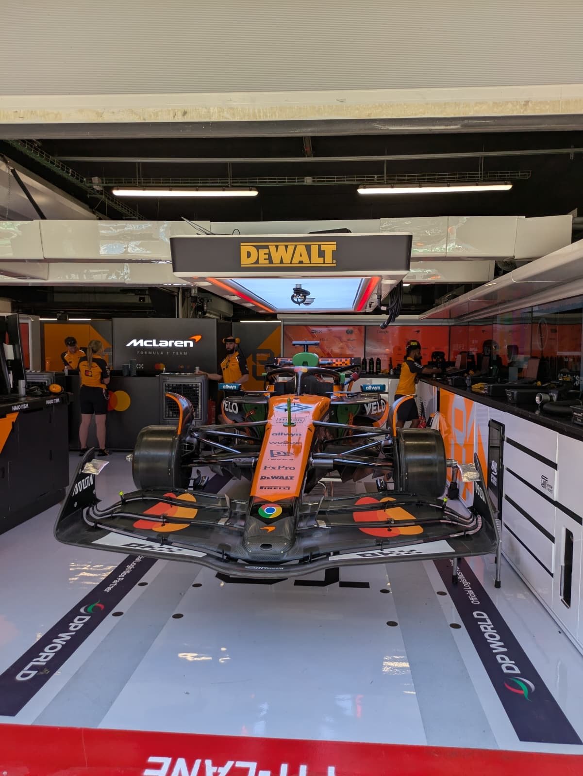 McLaren Formula 1 car inside the team garage, a working environment for an F1 content creator