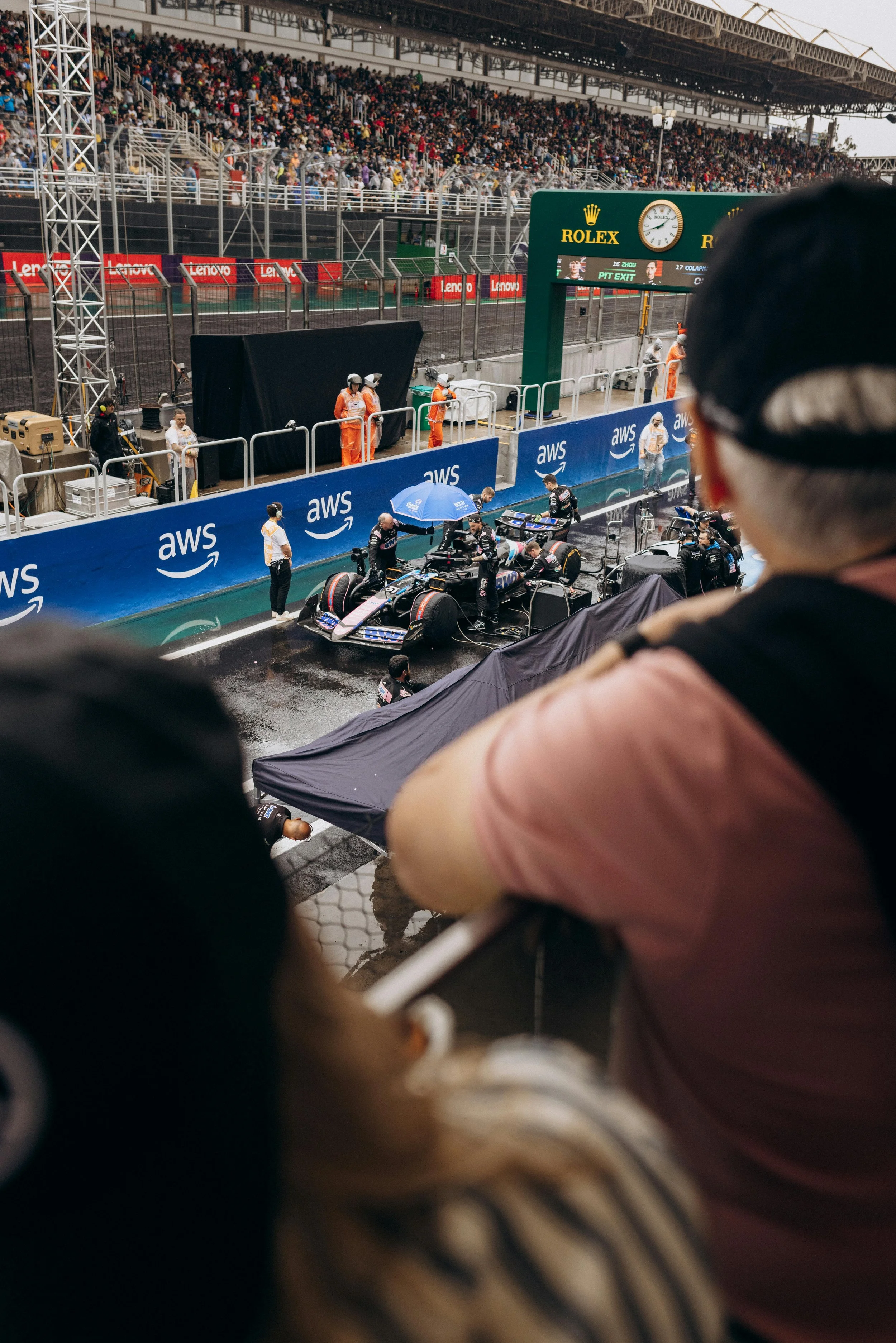 Fans watching Formula 1 track action during a race weekend, representing audience awareness and early-stage Formula 1 sponsorship ROI and brand visibility.