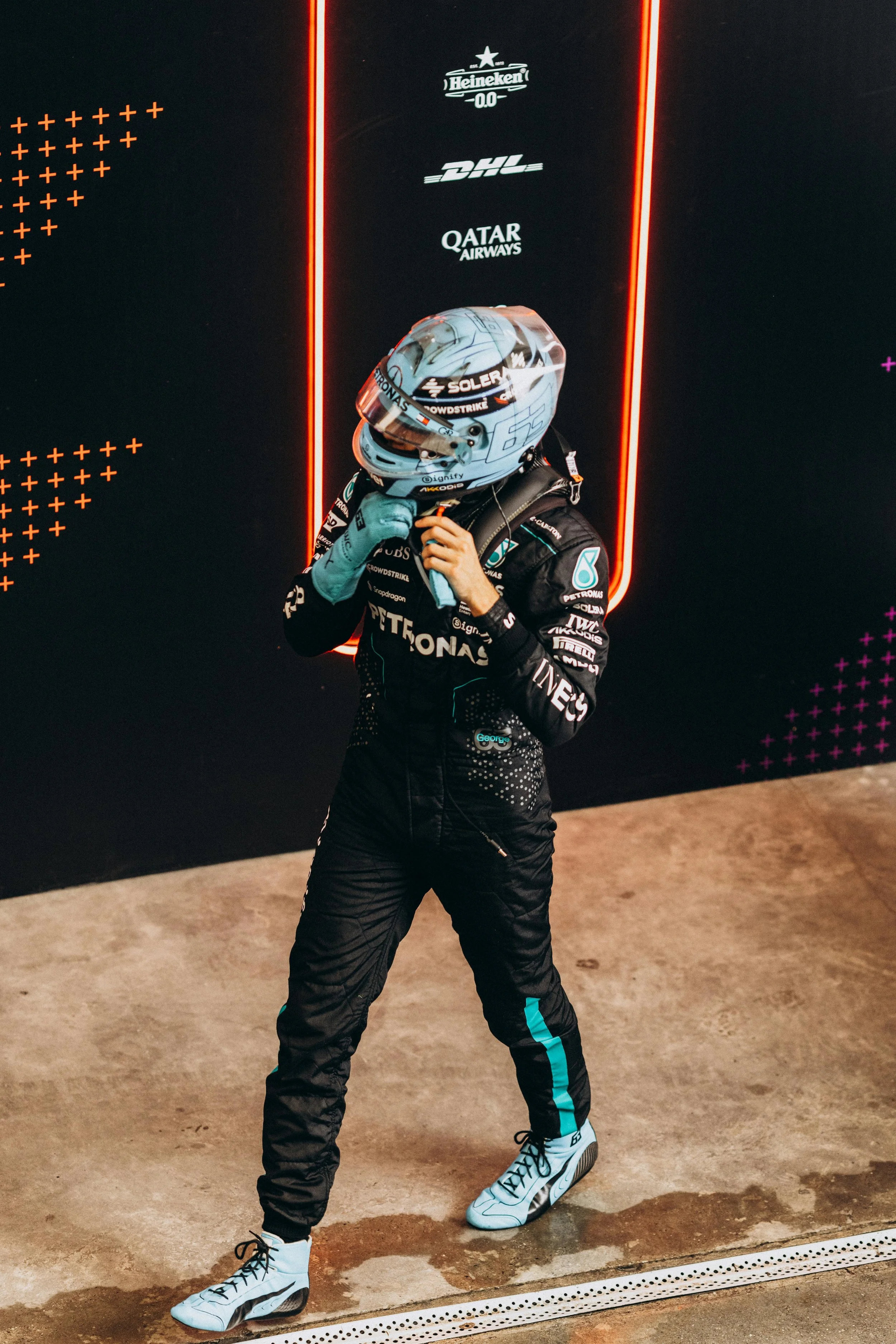 Formula 1 driver preparing for a filming day content shoot, used for sponsor and partner marketing