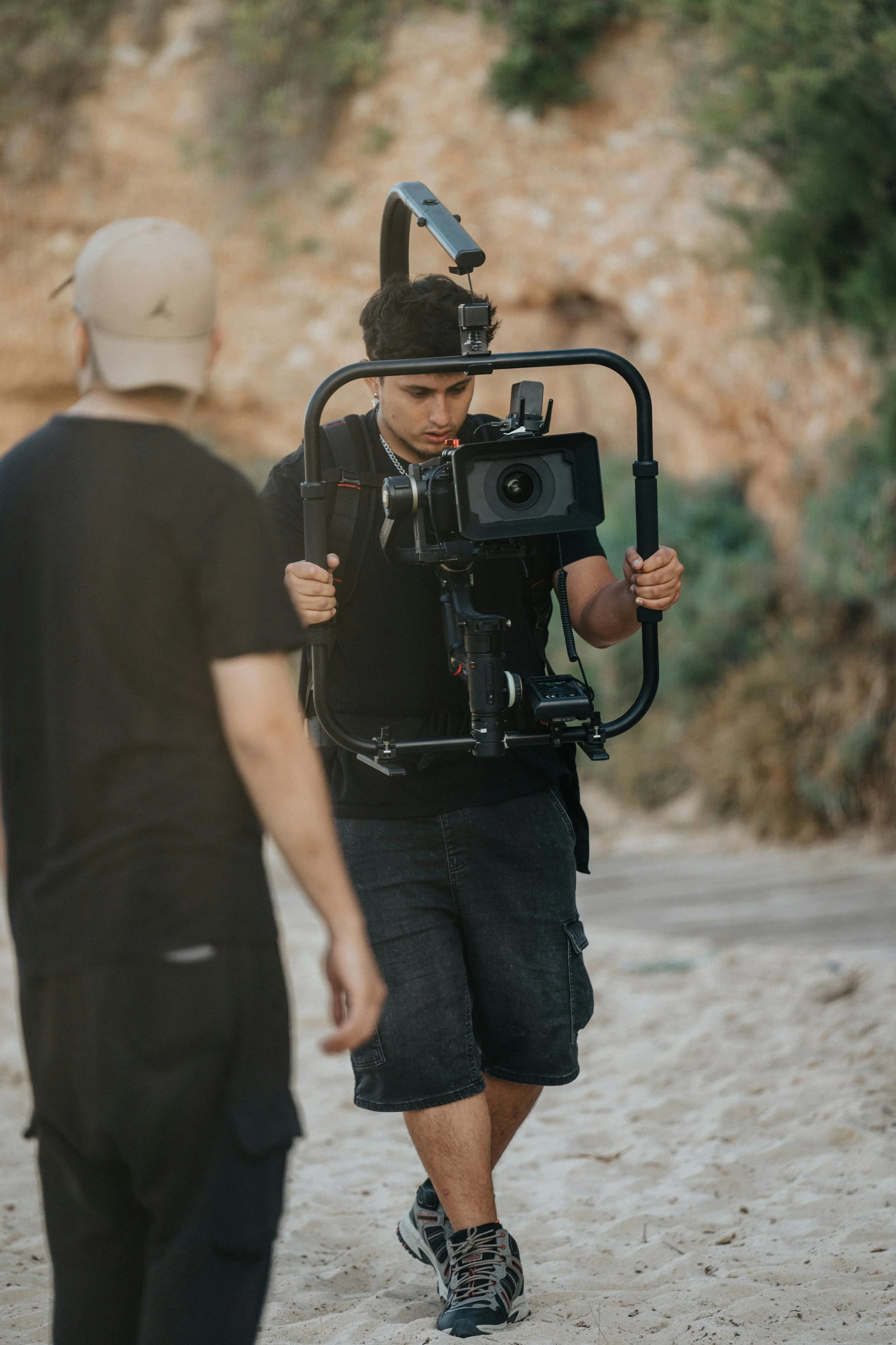 Camera operator filming content during a Formula 1 filming day using stabilised camera rig