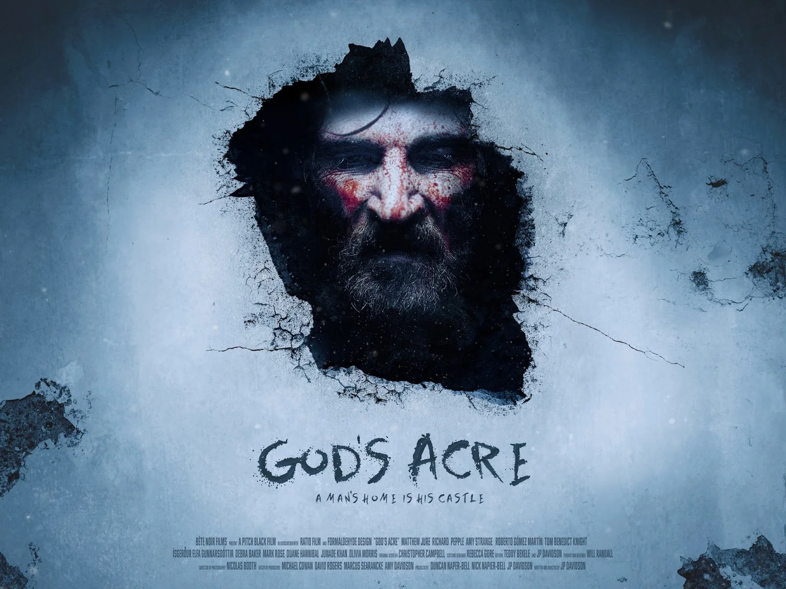 Dark, eerie poster for the movie 'God's Acre' showing a man's face with stormy weather effects, surrounded by cracked and broken ground, with the tagline 'A man's home is his castle'.